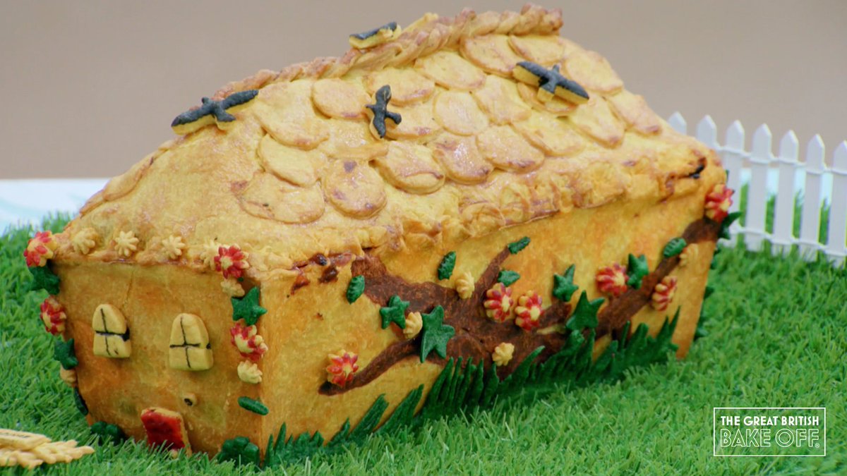 A hot water pastry pie made to look like a cottage, using coloured pastry inlays.