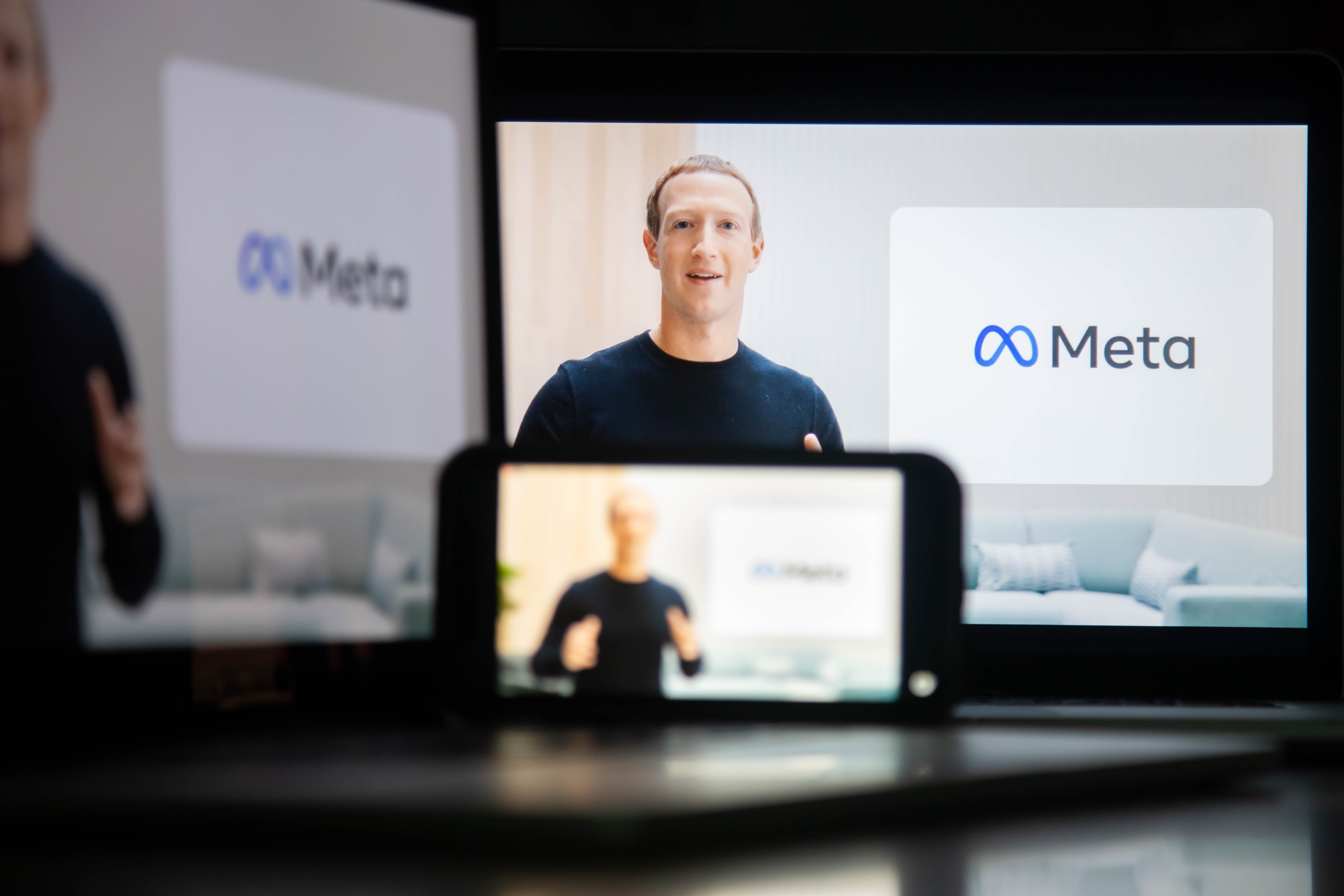 Three screens showing an image of Mark Zuckerberg and the name Meta with its logo.