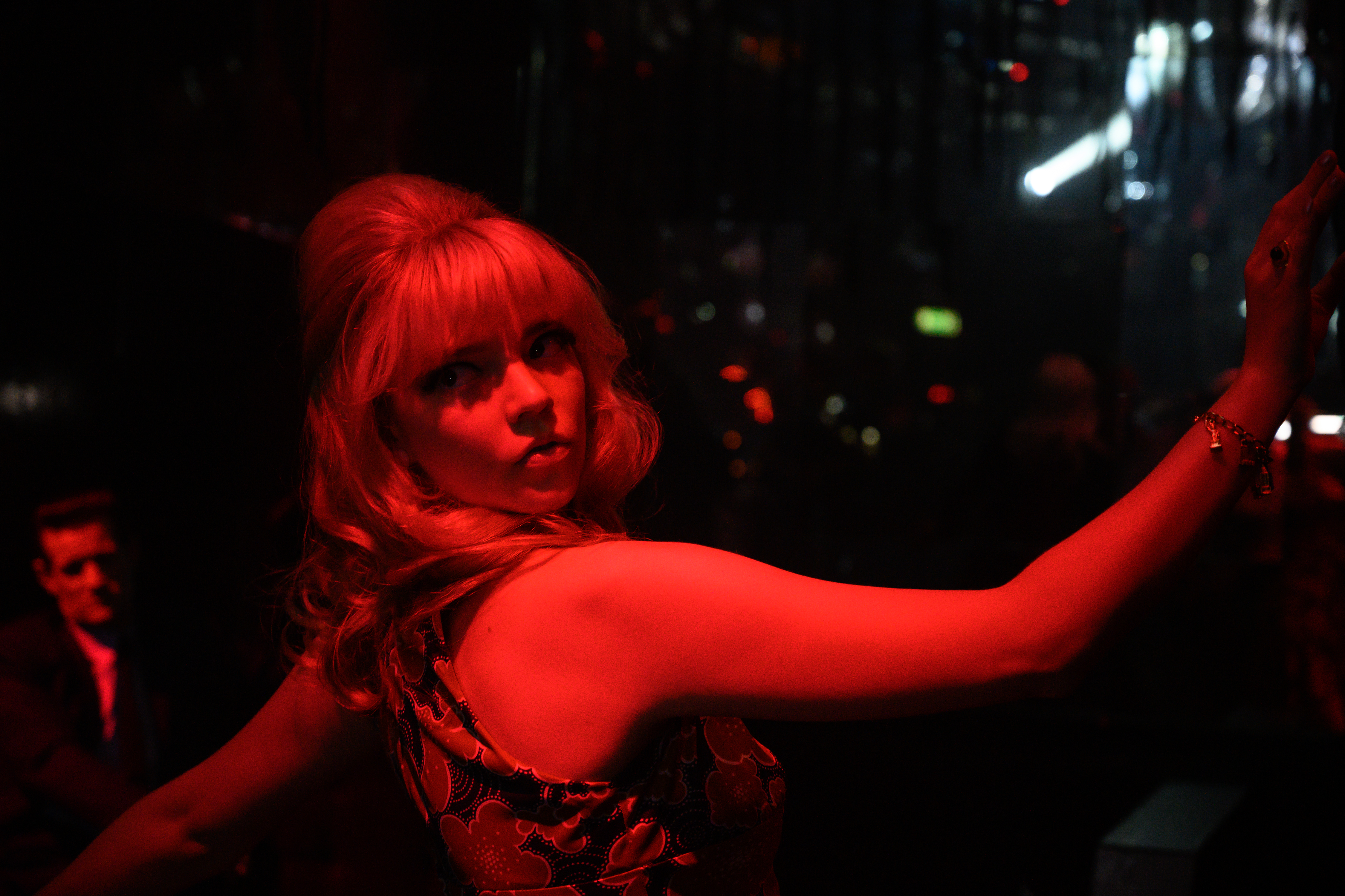 Anya Taylor-Joy poses in deep red light in Last Night in Soho