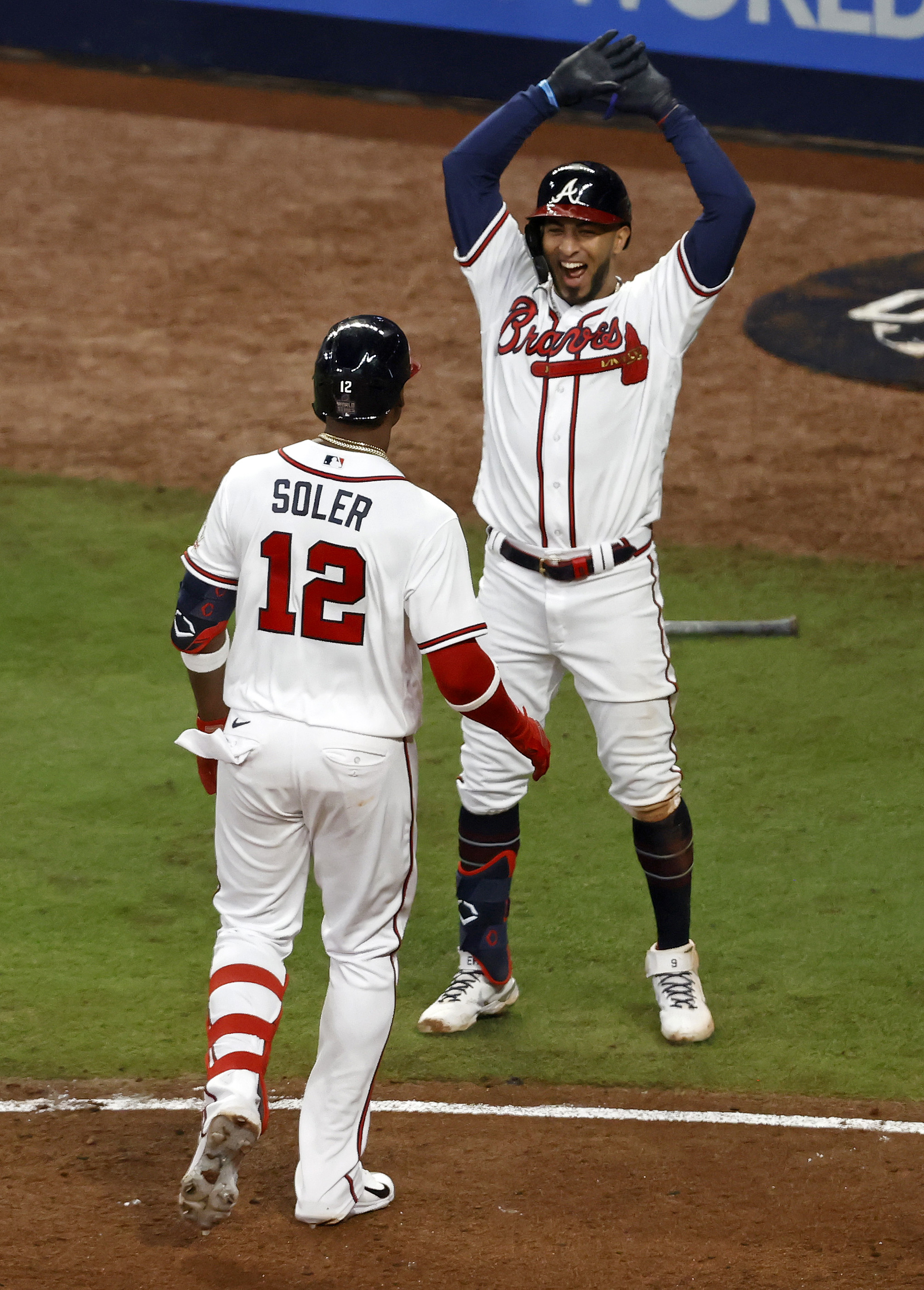 Jorge Soler #12 of the Atlanta Braves is congratulated by Eddie Rosario #8 after hitting a solo home run against the Houston Astros during the seventh inning in Game Four of the World Series at Truist Park on October 30, 2021 in Atlanta, Georgia.
