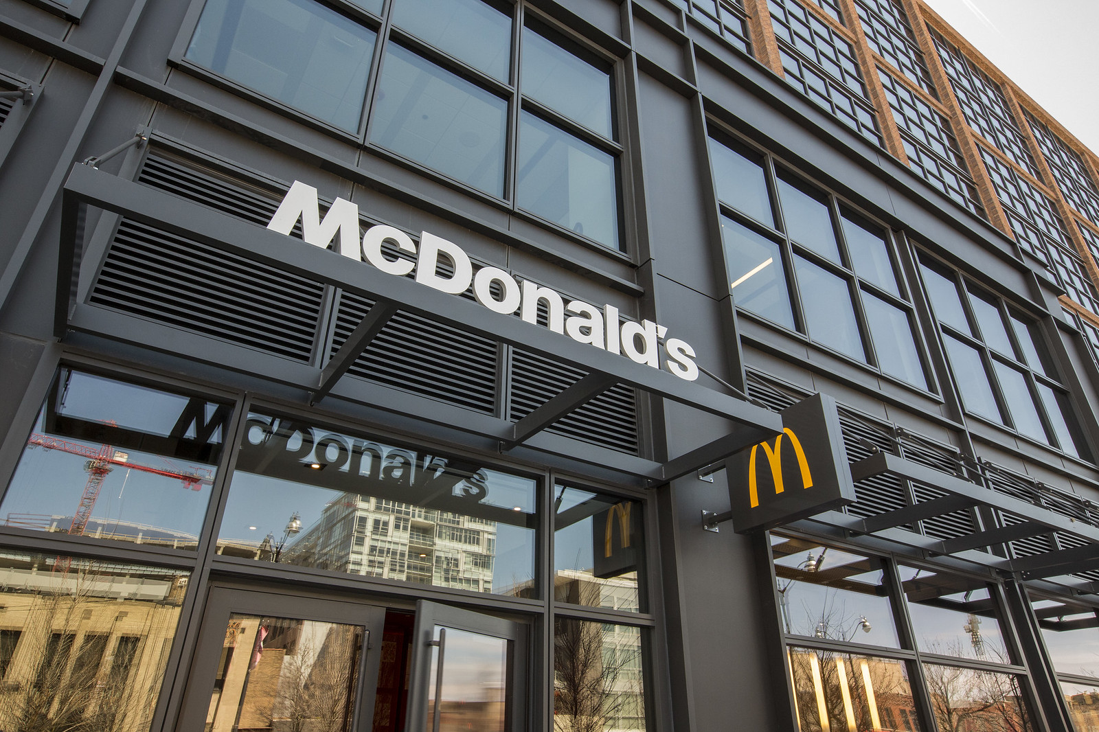 A glassed office building with the golden “McDonald’s” logo.