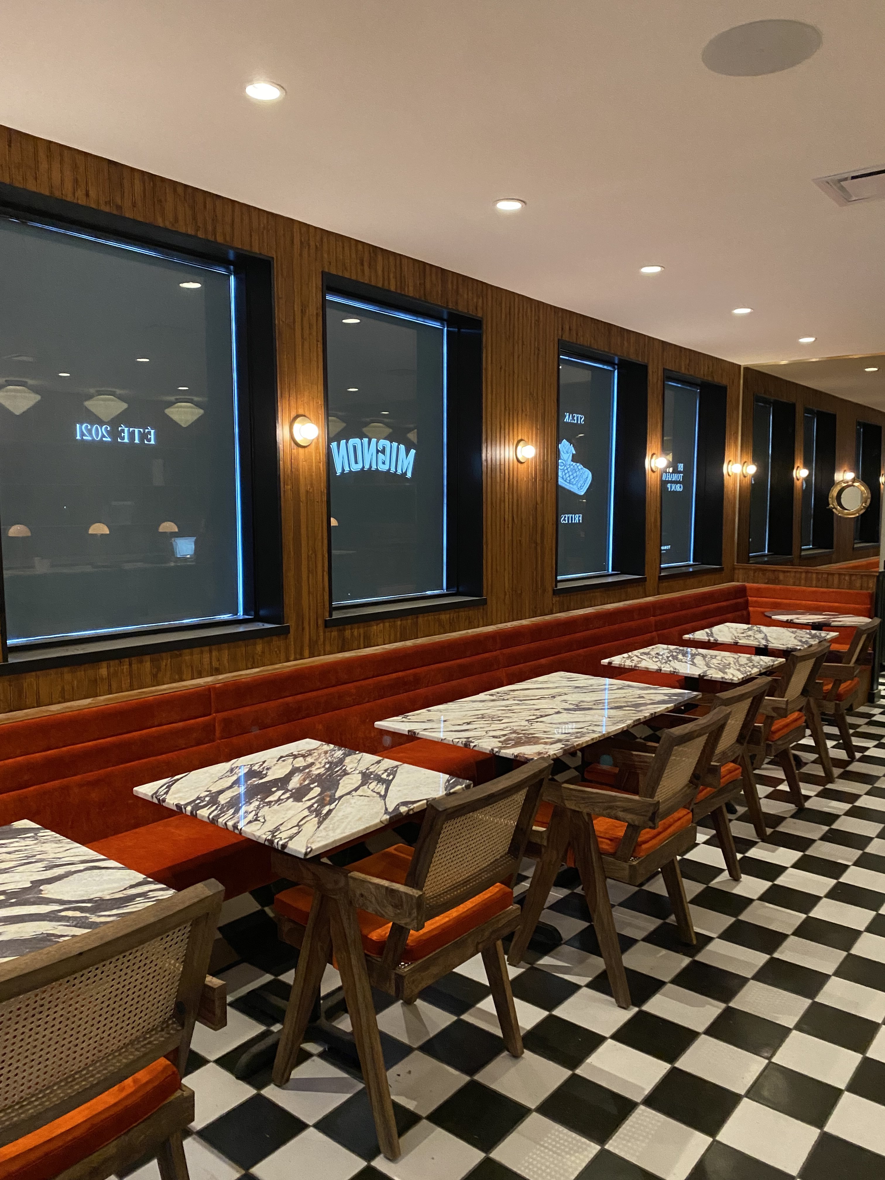 restaurant with checker floors and red seat and wood walls