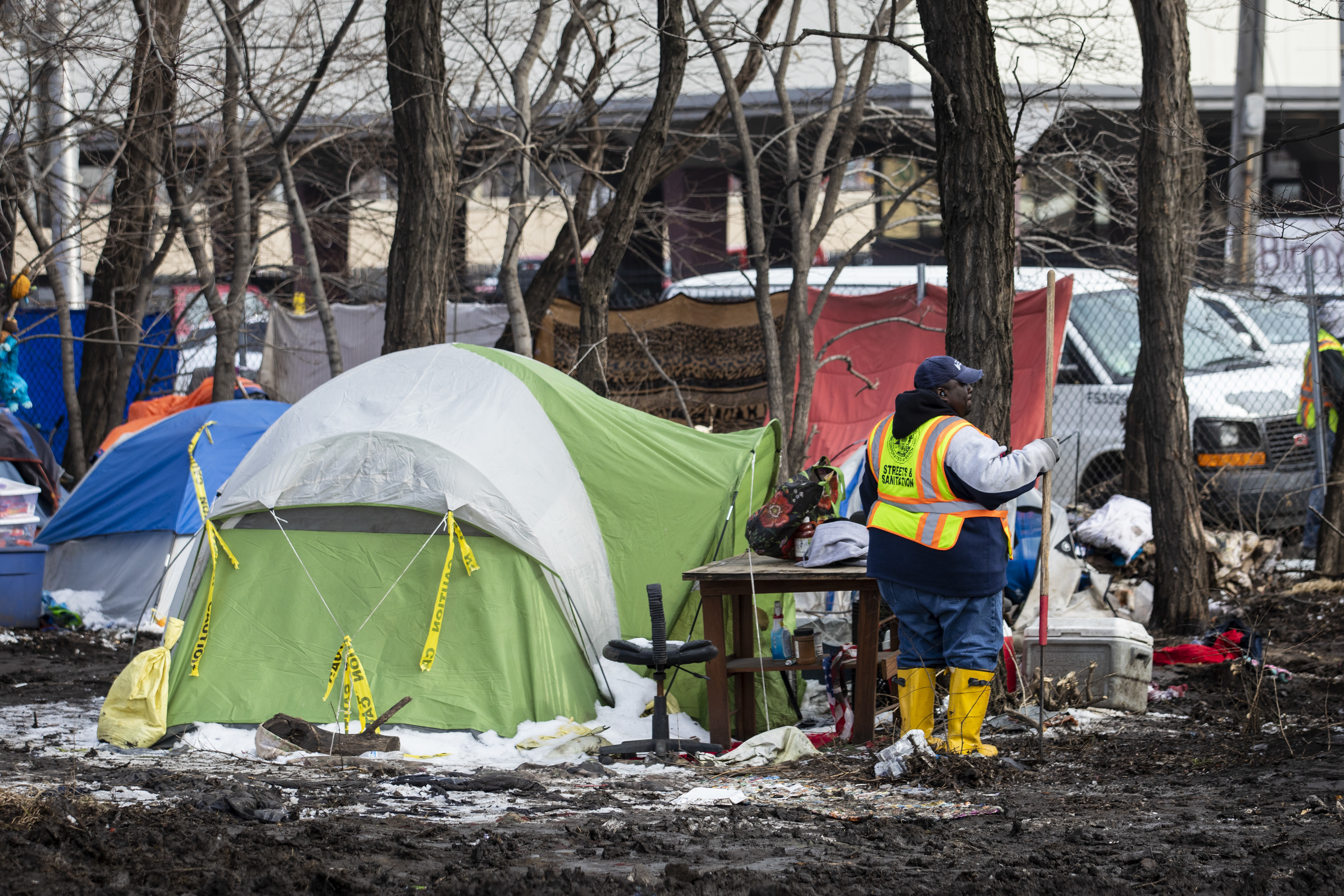 Workers from the city’s Department of Streets and Sanitation clear out a homeless encampment near South Desplaines Street and West Roosevelt Road.