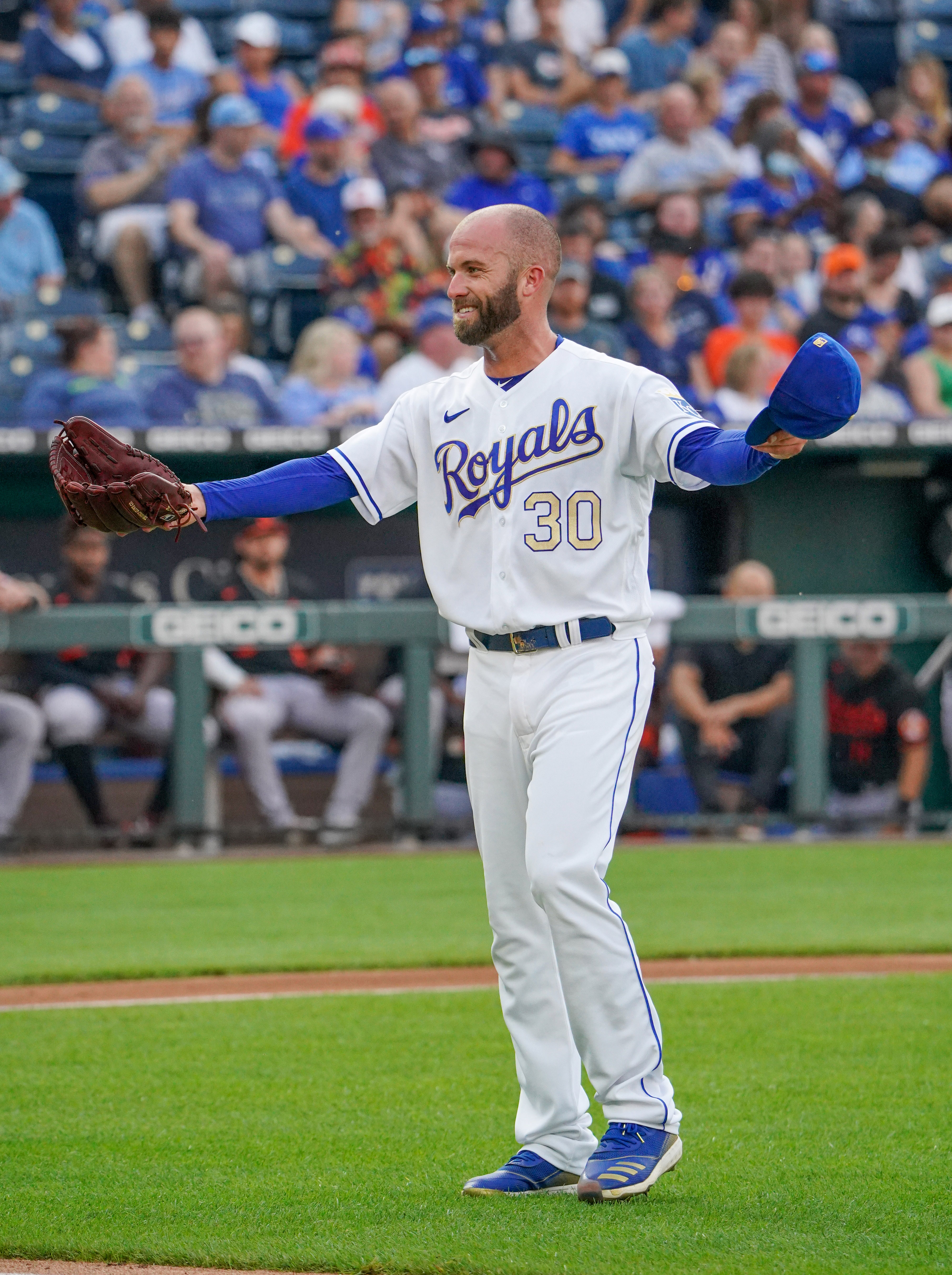 Kansas City Royals starting pitcher Danny Duffy (30) walks toward umpires to have his hat and glove inspected in between innings during the game against the Baltimore Orioles at Kauffman Stadium.