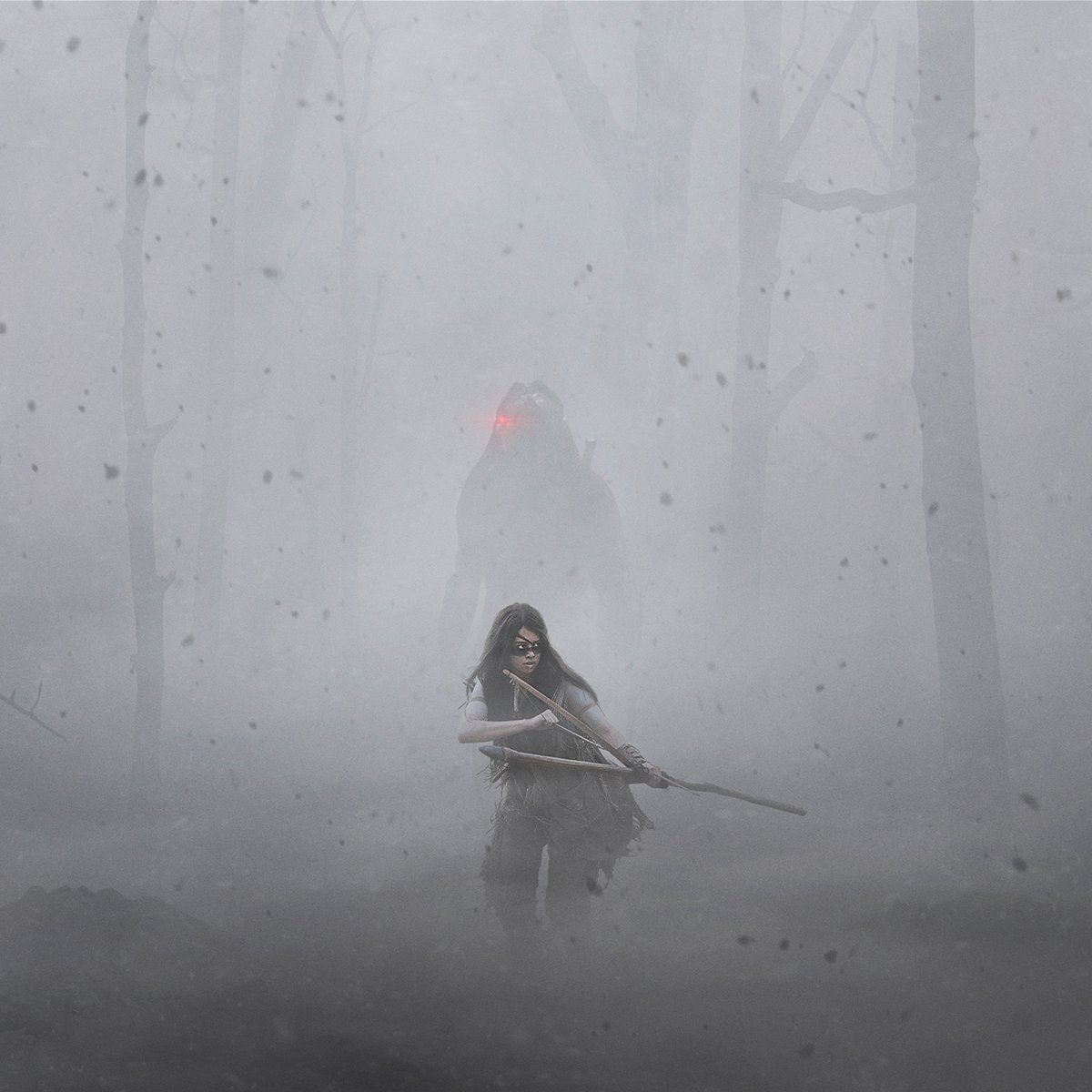 A woman walking through the woods while the Predator follows her in the movie Prey