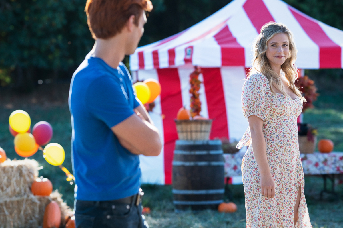 Archie and Betty look at each other at a carnival during the season 6 premiere of Riverdale