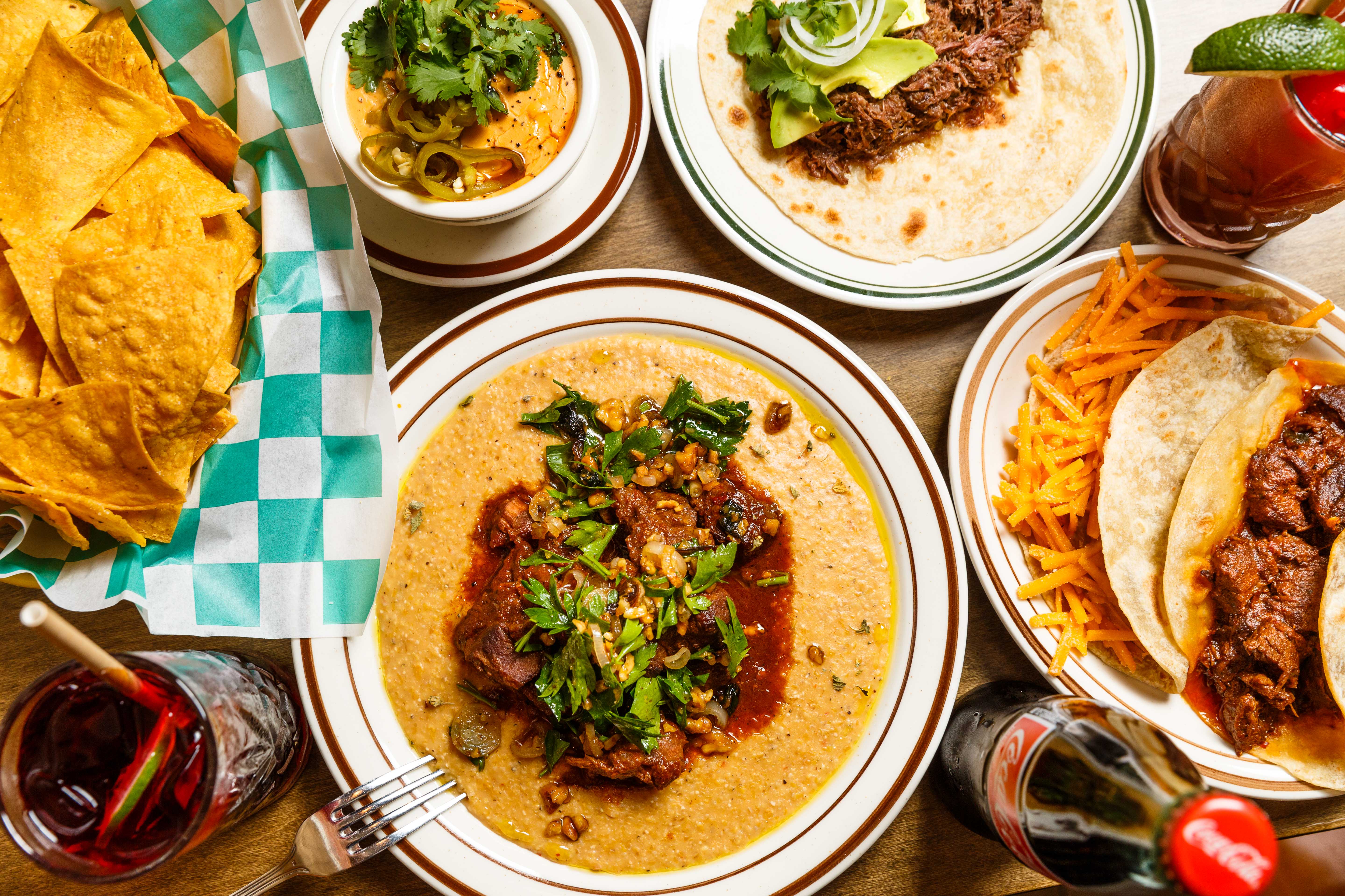 An overhead photograph of chips and tacos made with corn and flour tortillas at Yellow Rose.