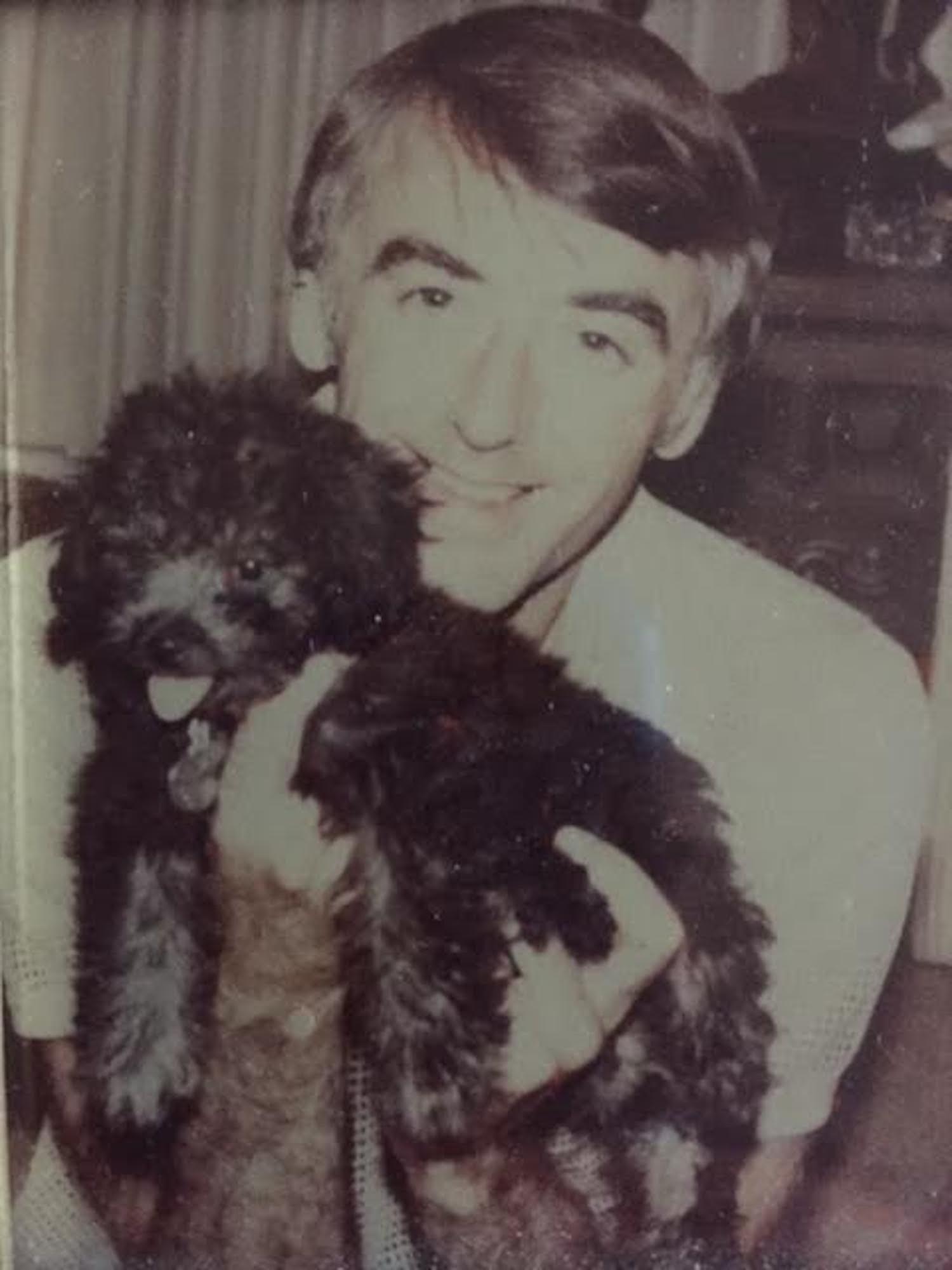 Court reporter Jerry L. Martin holding one of his beloved dogs.