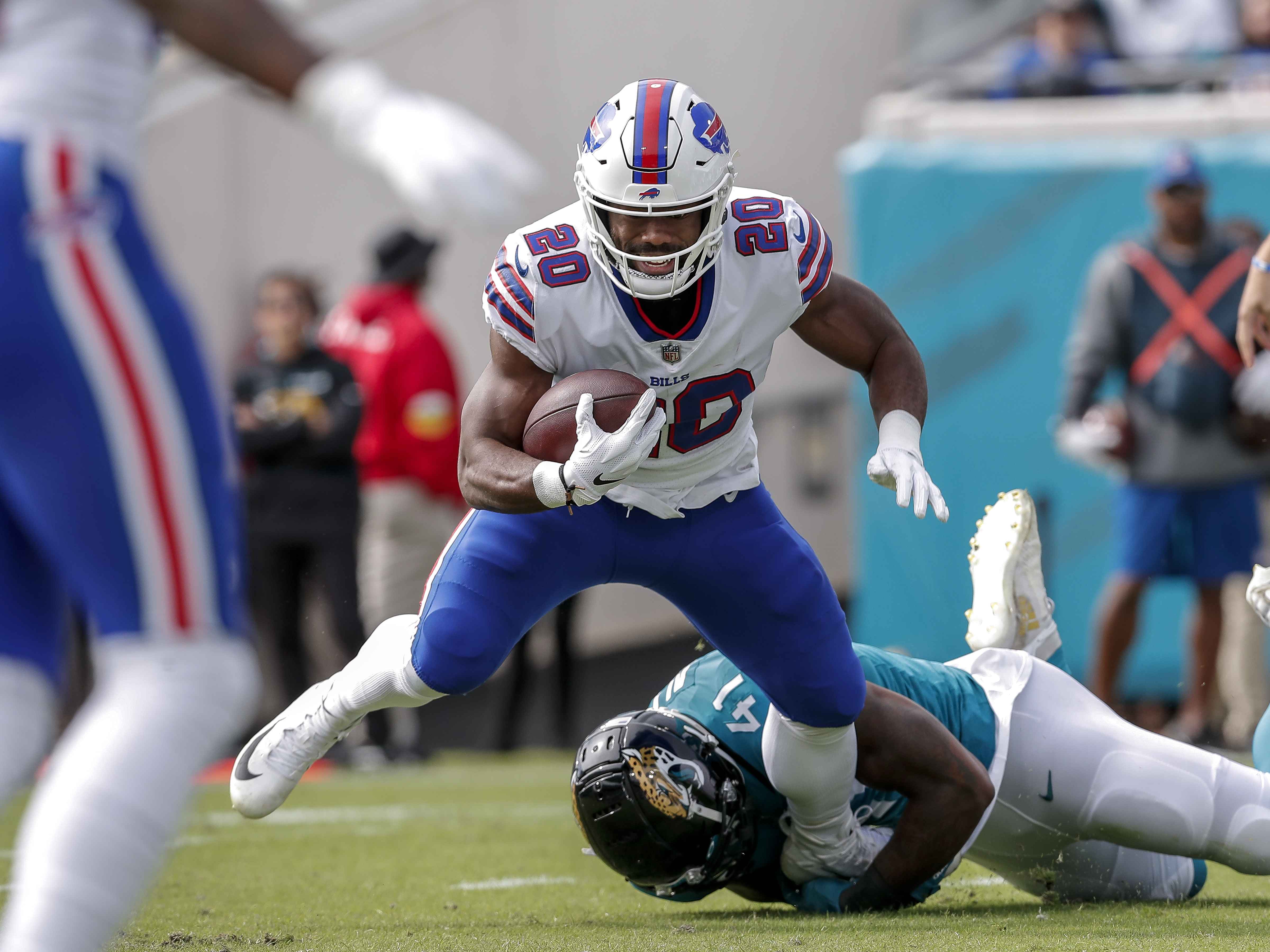 Running back Zack Moss #20 of the Buffalo Bills is tackled by the ankles by Linebacker Josh Allen #41 of the Jacksonville Jaguars during the game at TIAA Bank Field on November 7, 2021 in Jacksonville, Florida.