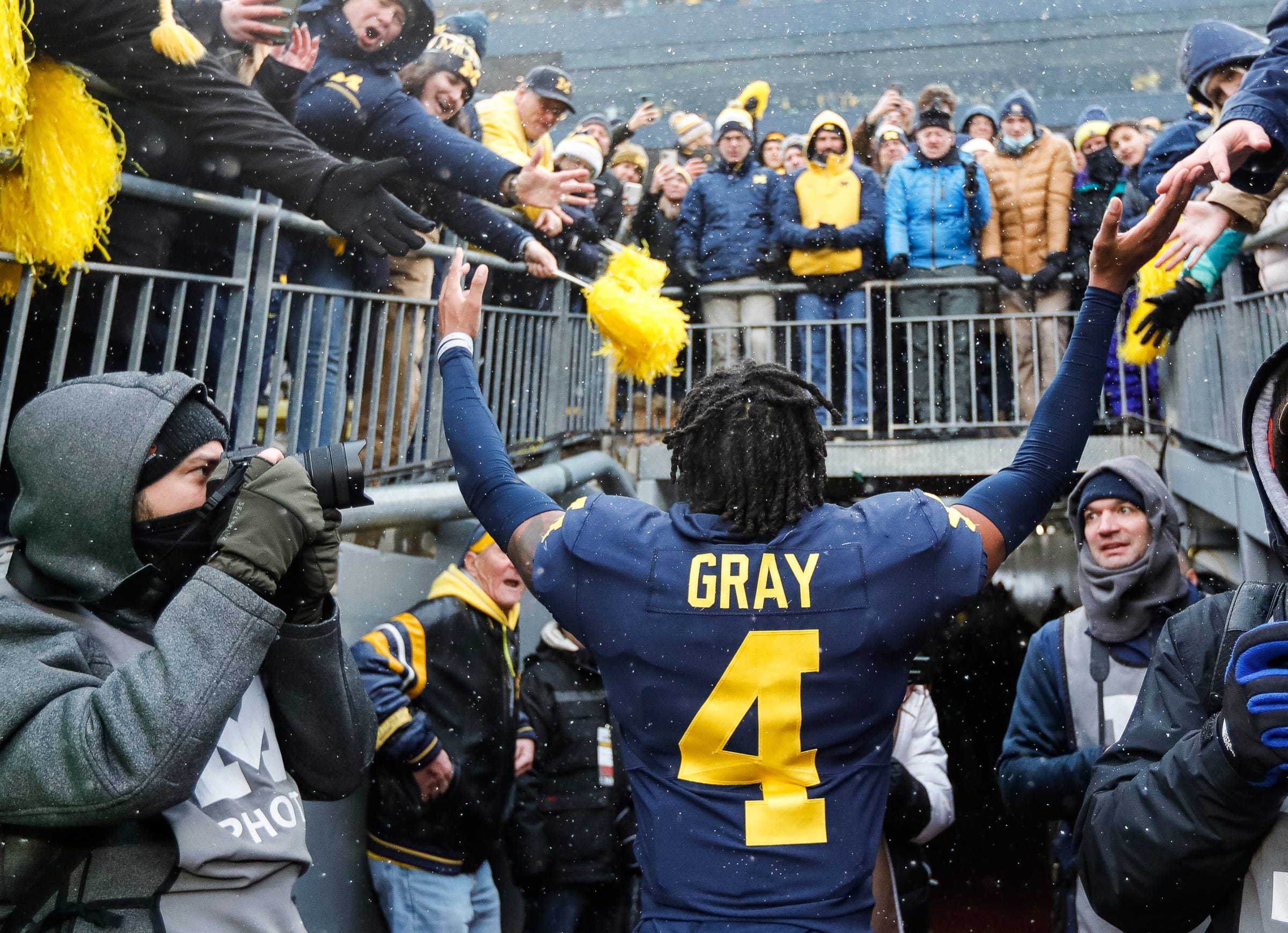 Michigan defensive back Vincent Gray (4) waves at fans as he walks up the tunnel after the Wolverines won 42-27 against Ohio State at Michigan Stadium in Ann Arbor on Saturday, Nov. 27, 2021.