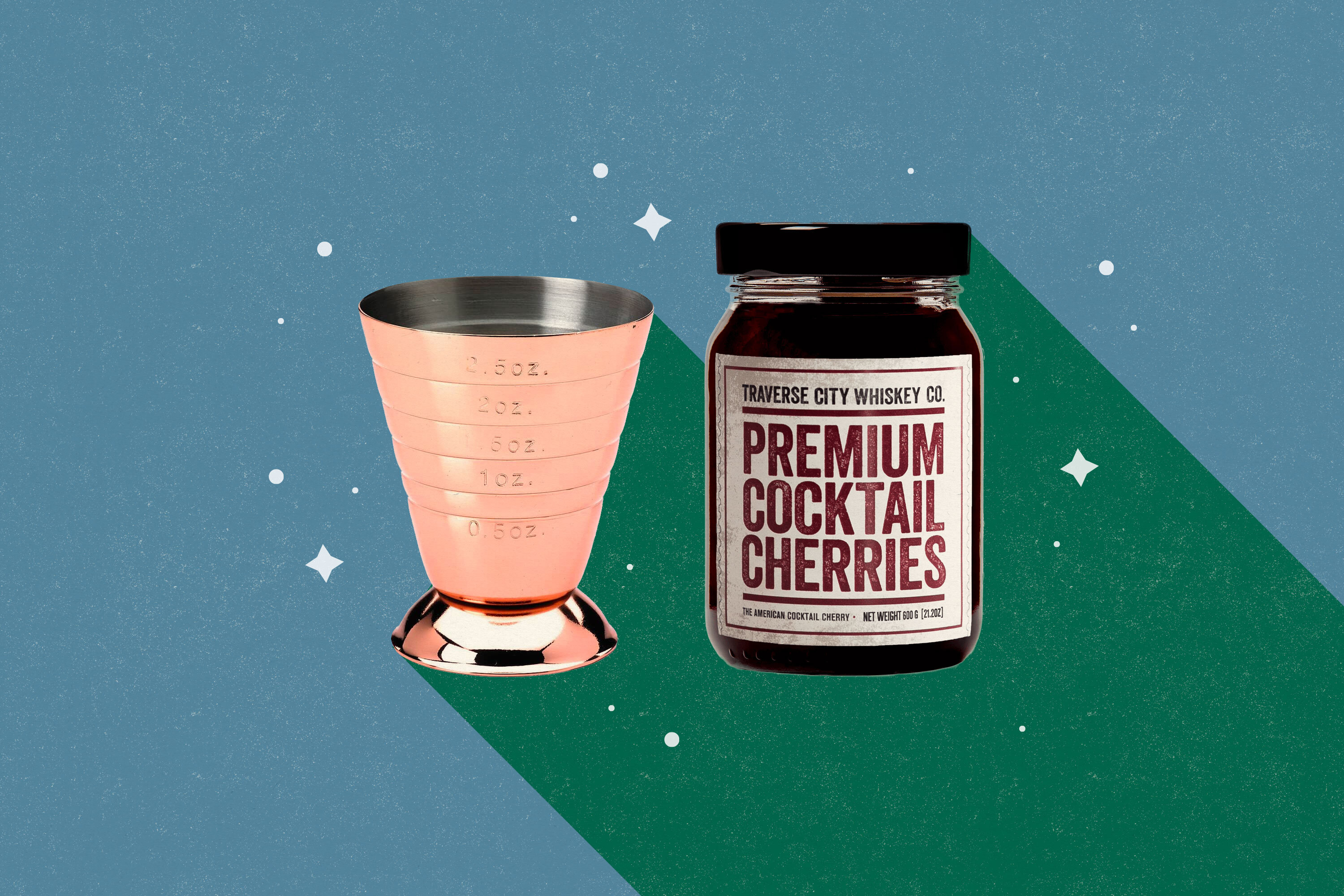 A copper jigger and a jar of cherries on a green and blue background