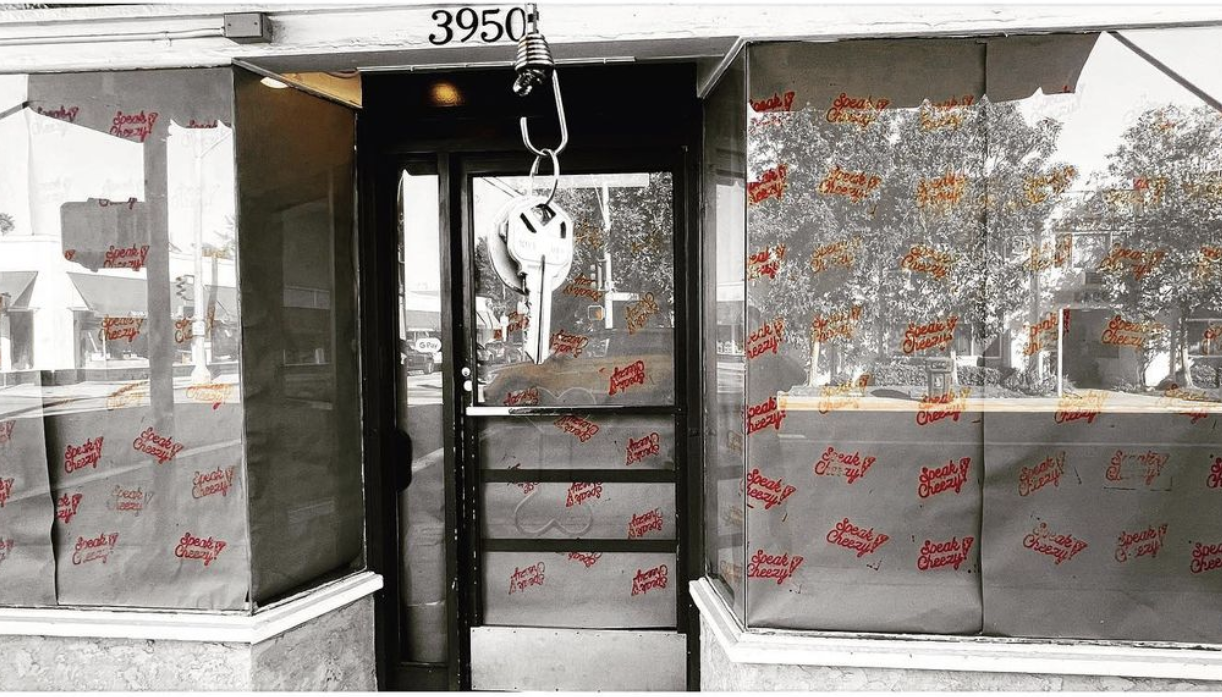 A glassy storefront papered over with a pizza restaurant’s logo.