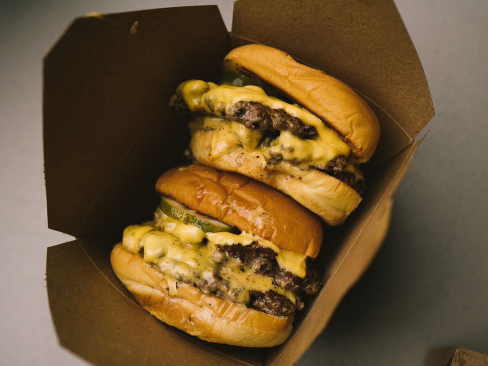 Two burgers in a cardboard box