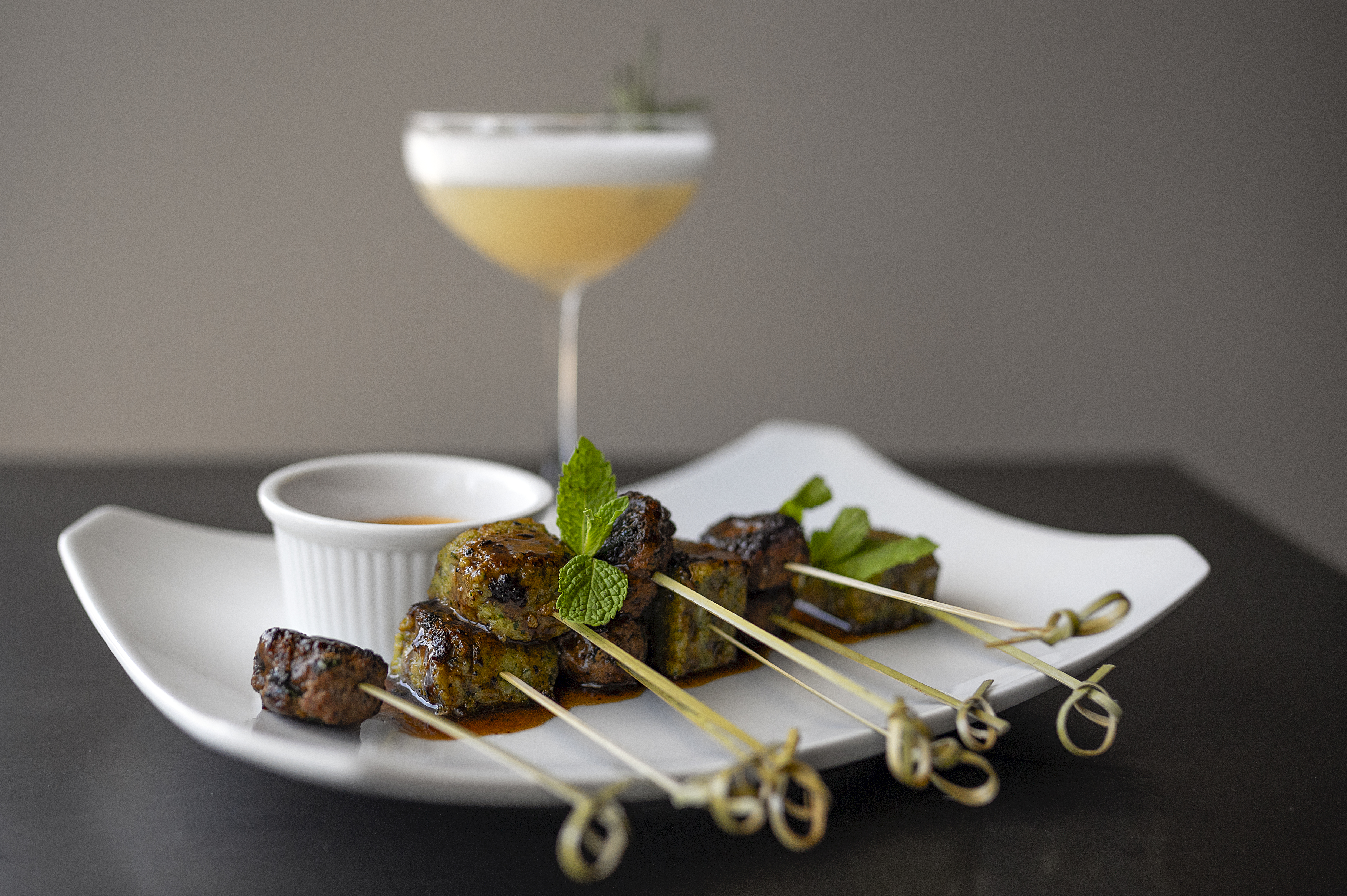 Clique Bistro’s spiced rubbed lamb kafta with cumin polenta cake and harissa sauce