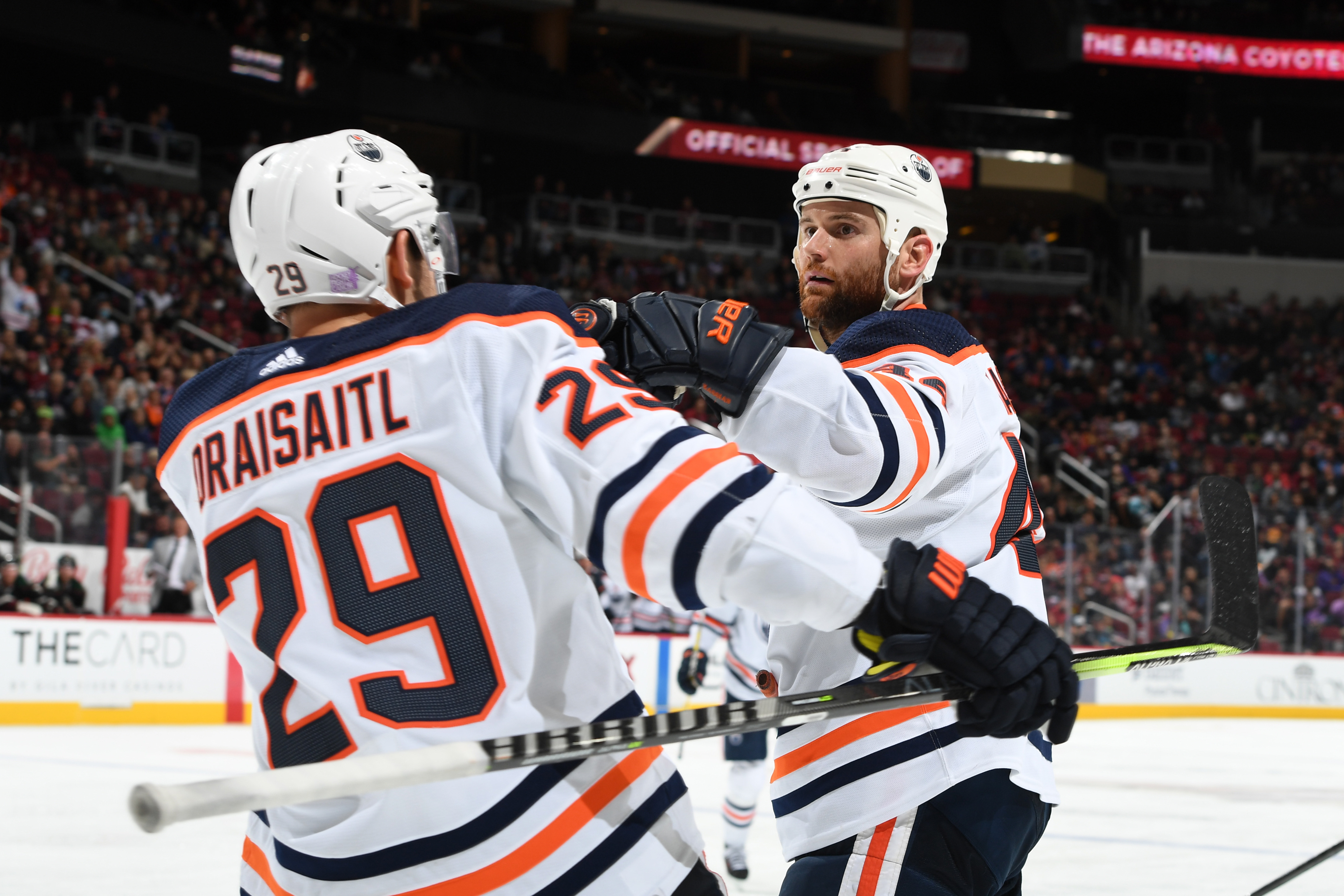 Zack Kassian #44 of the Edmonton Oilers celebrates with Leon Draisaitl #29 after scoring a goal against the Arizona Coyotes during the third period at Gila River Arena on November 24, 2021 in Glendale, Arizona.