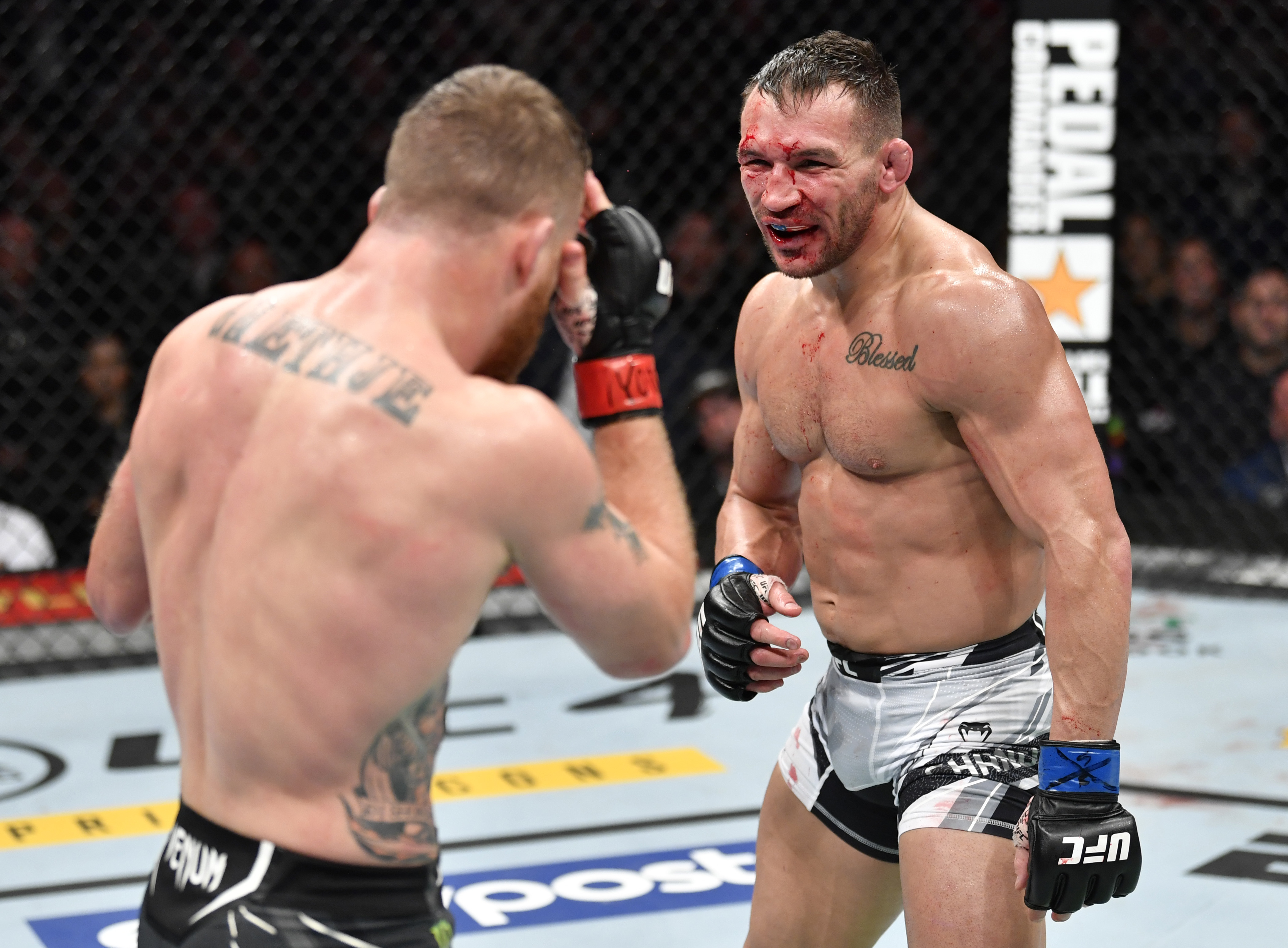 A bloodied up Michael Chandler stares down Justin Gaethje during their UFC 268 fight. UFC 268: Gaethje v Chandler