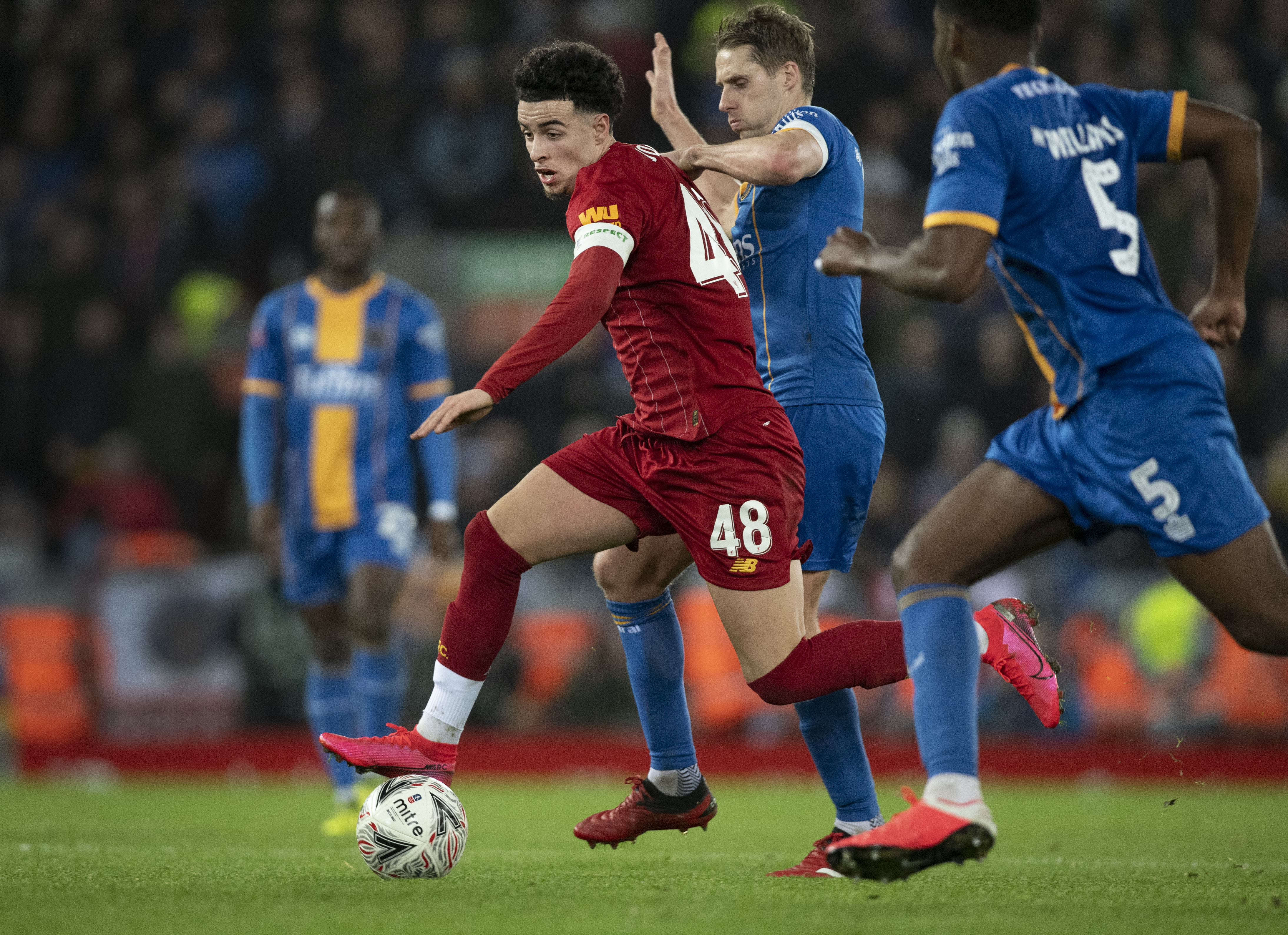 Curtis Jones of Liverpool and David Edwards of Shrewsbury Town in action during the FA Cup Fourth Round Replay match between Liverpool and Shrewsbury Town at Anfield on February 4, 2020 in Liverpool, England.