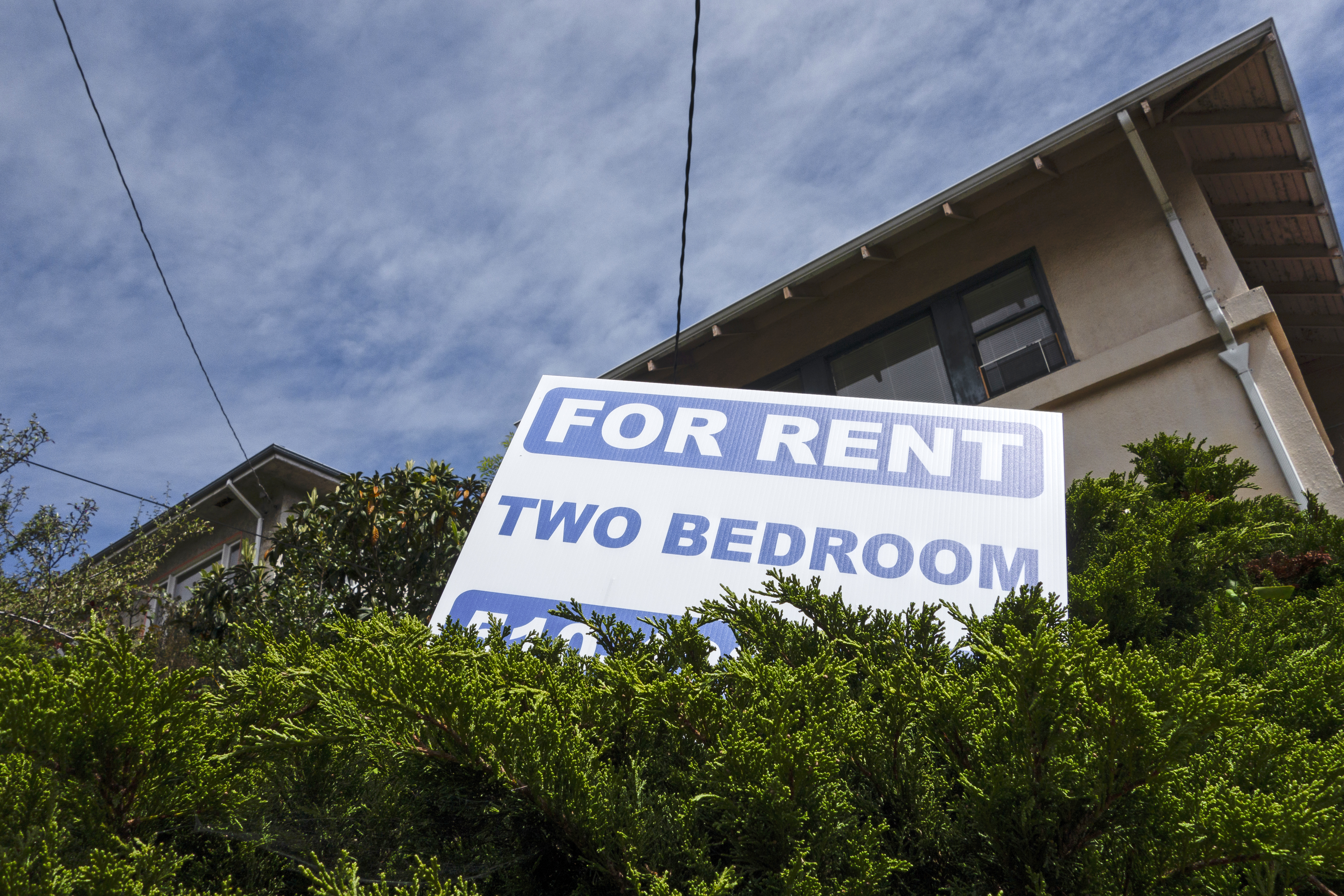 A sign outside a home, advertising a two-bedroom apartment for rent.
