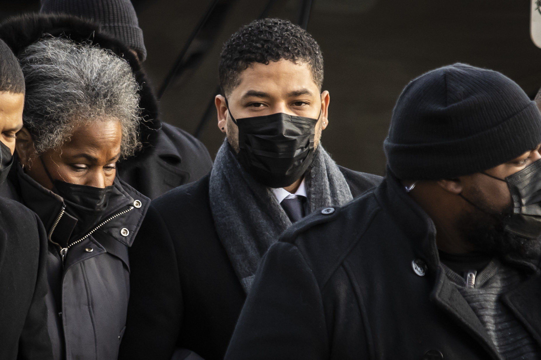 Flanked by family members, supporters, attorneys and bodyguards, former “Empire” star Jussie Smollett walks into the Leighton Criminal Courthouse, Tuesday morning, Dec. 7, 2021.