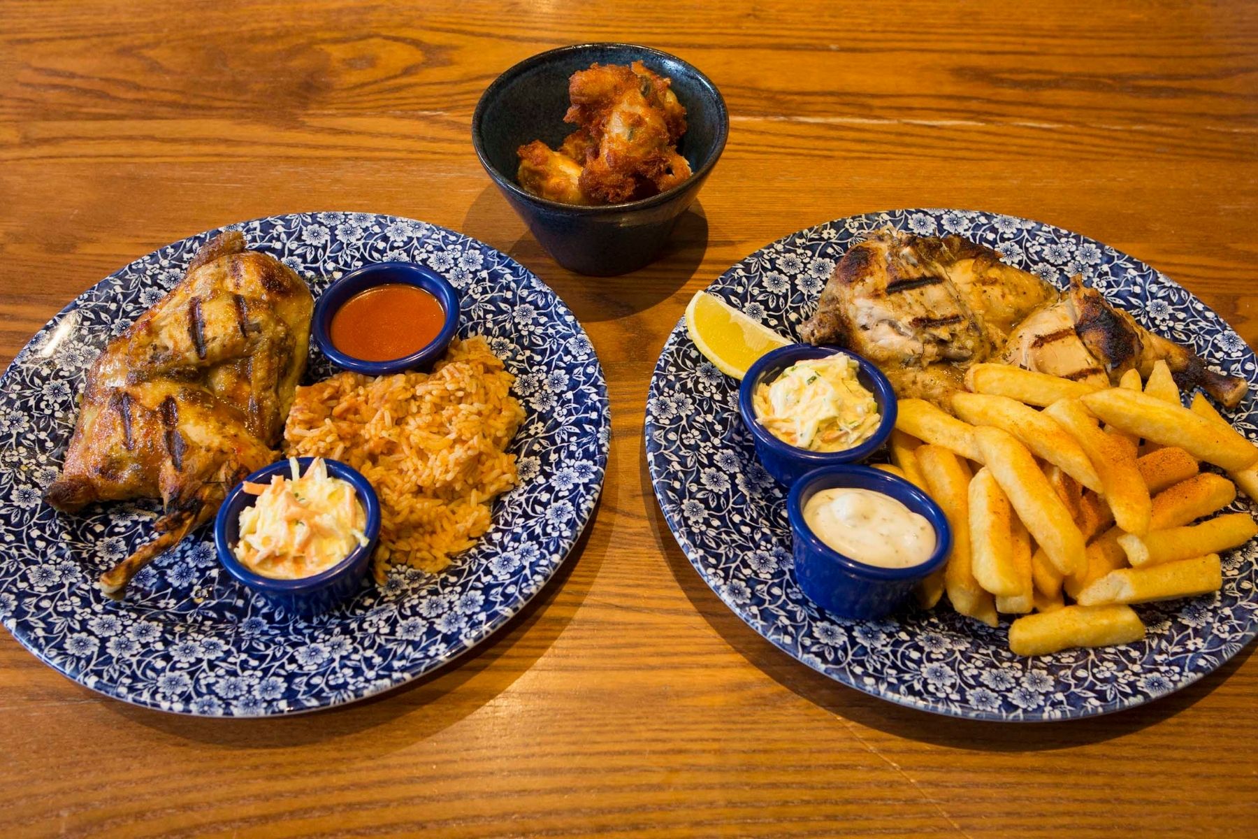 Two blue plates of grilled chicken and chips from JD Wetherspoon