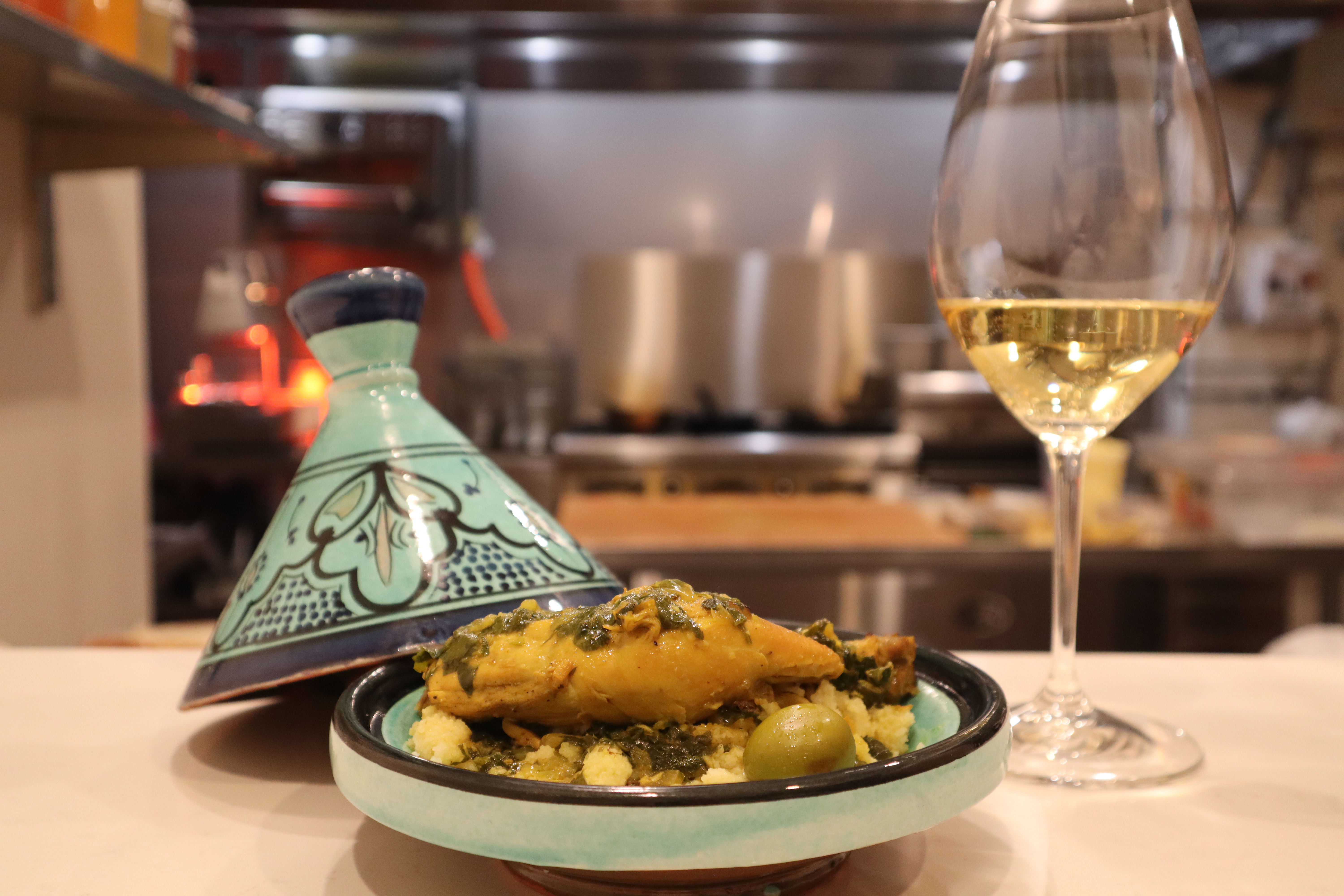 The chicken tagine main with a glass of white wine.