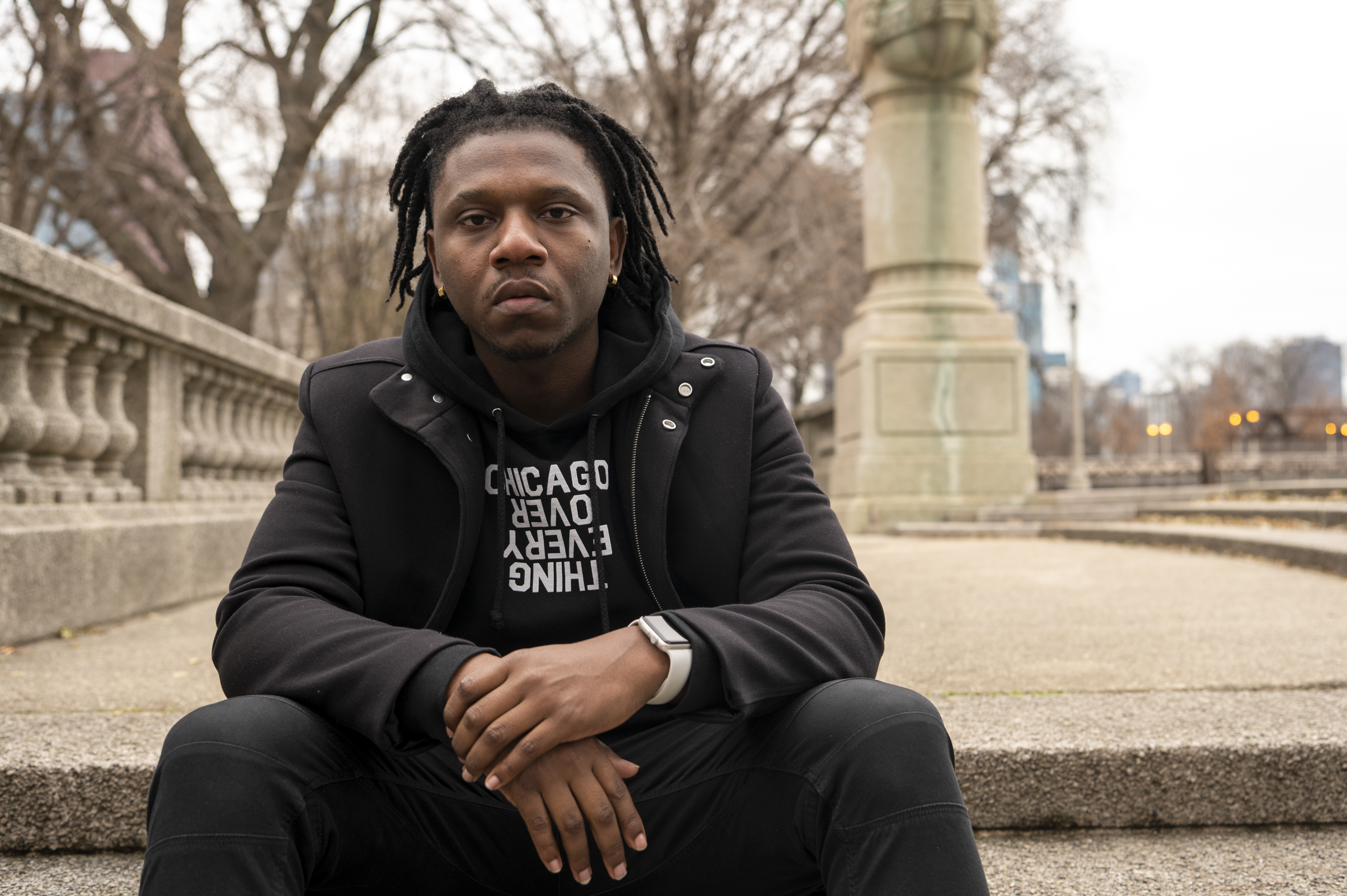 Matt Muse, a local hip-hop artist, sits in Grant Park, Thursday, Dec. 9, 2021. Muse is celebrating the third year of his “Love &amp; Nappyness” hair and skin care drive with a benefit concert at the Metro on Dec. 17.