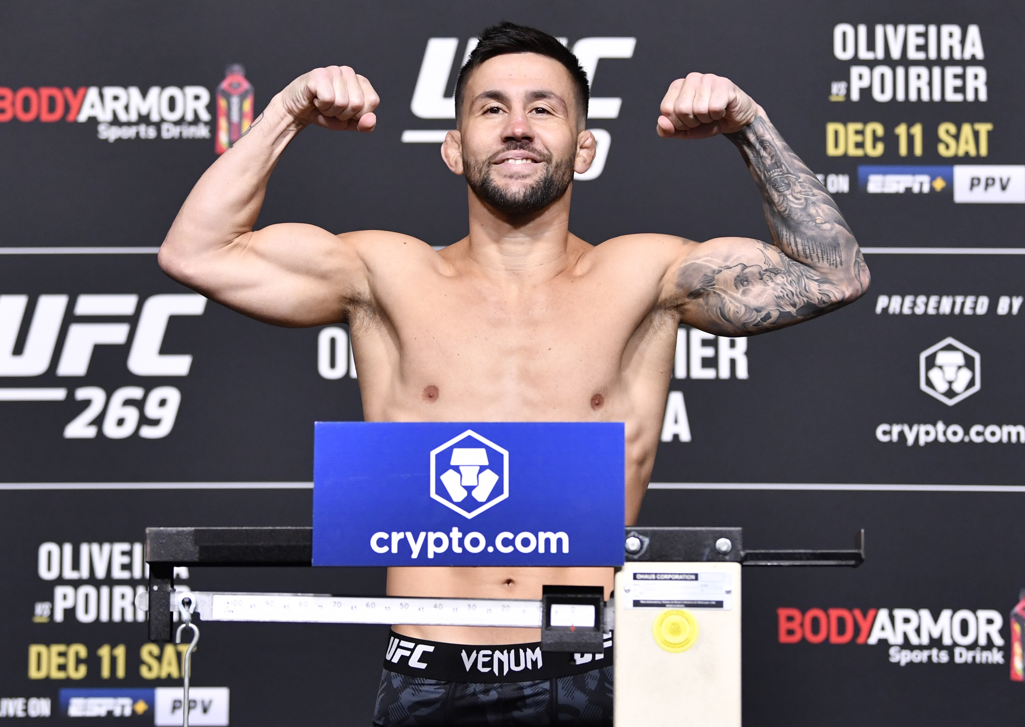 Pedro Munhoz of Brazil poses on the scale during the UFC 269 official weigh-in at UFC APEX on December 10, 2021 in Las Vegas, Nevada.