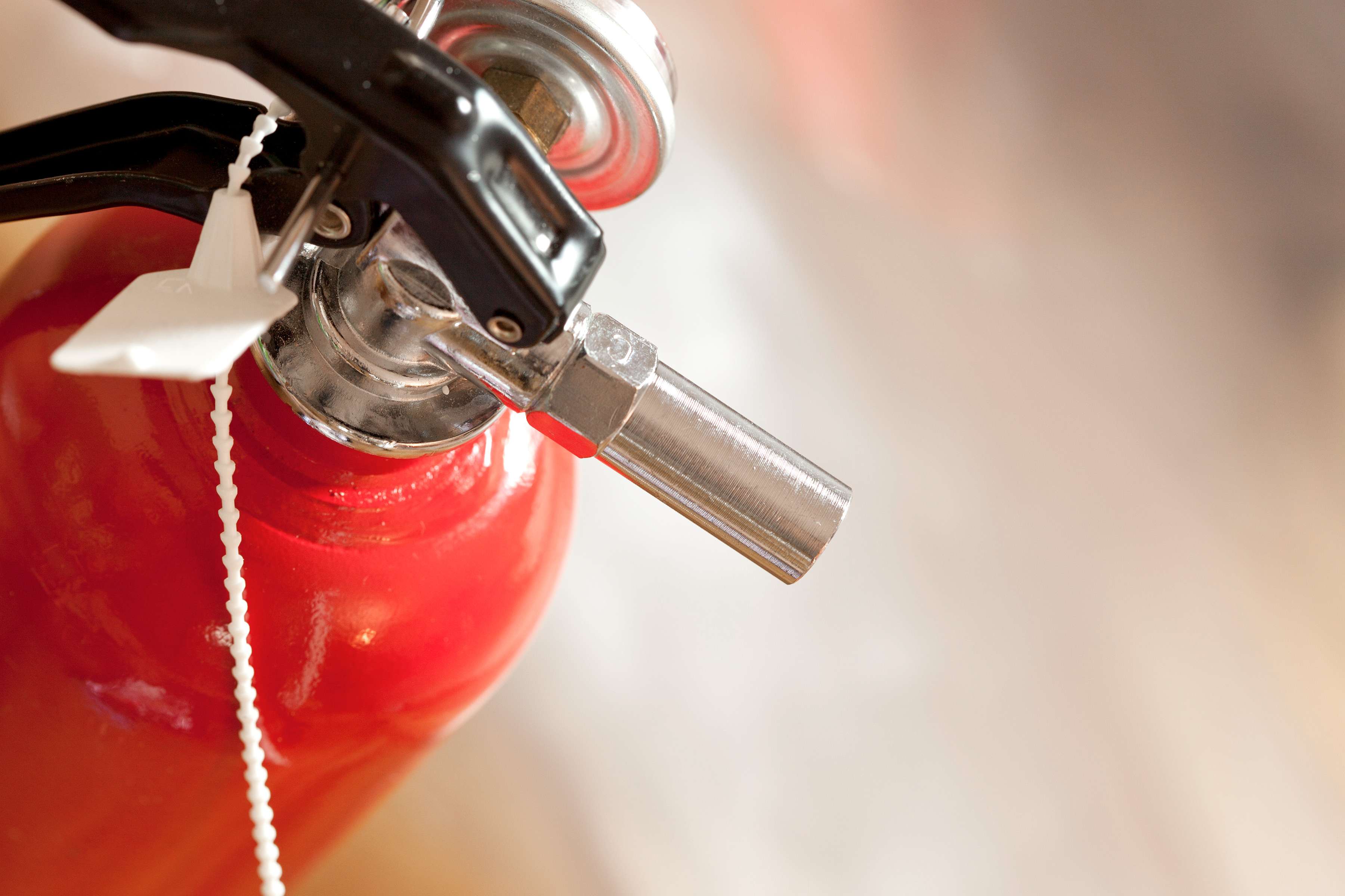 Close up of the top of a fire extinguisher