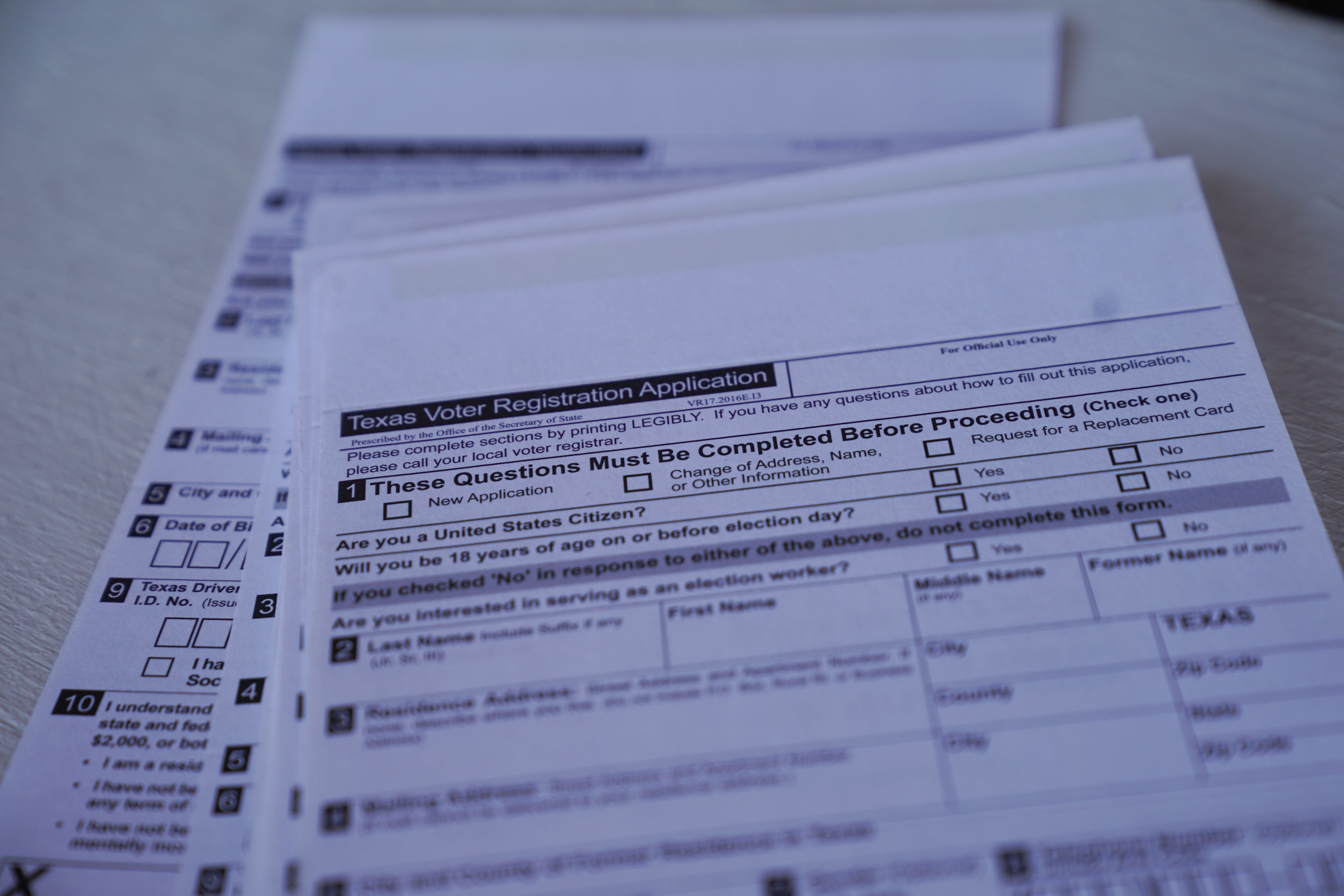 A stack of blank Texas voter registration forms
