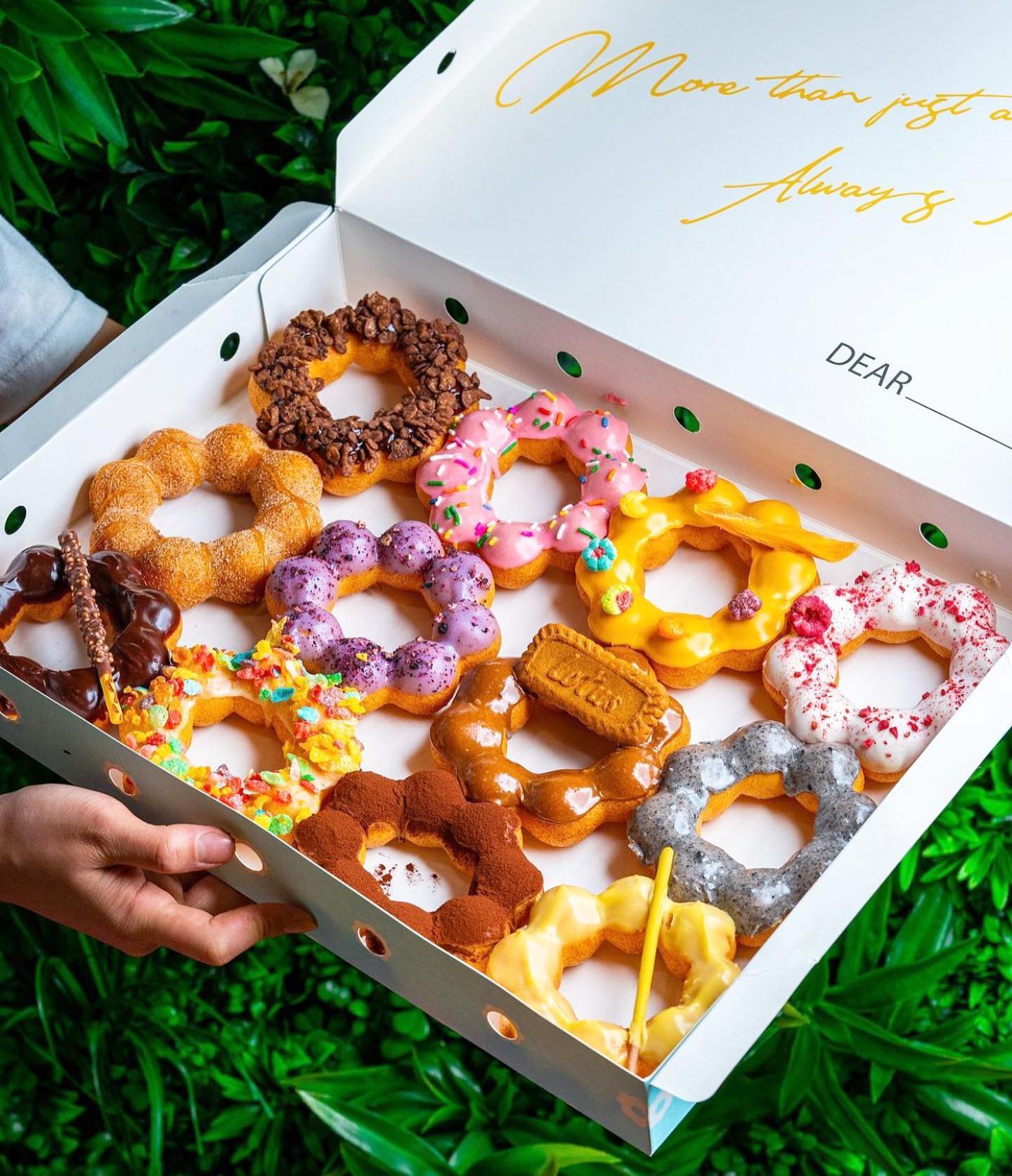 A box of colorful one dozen mochi doughtnuts from Mochinut opening in Atlanta.