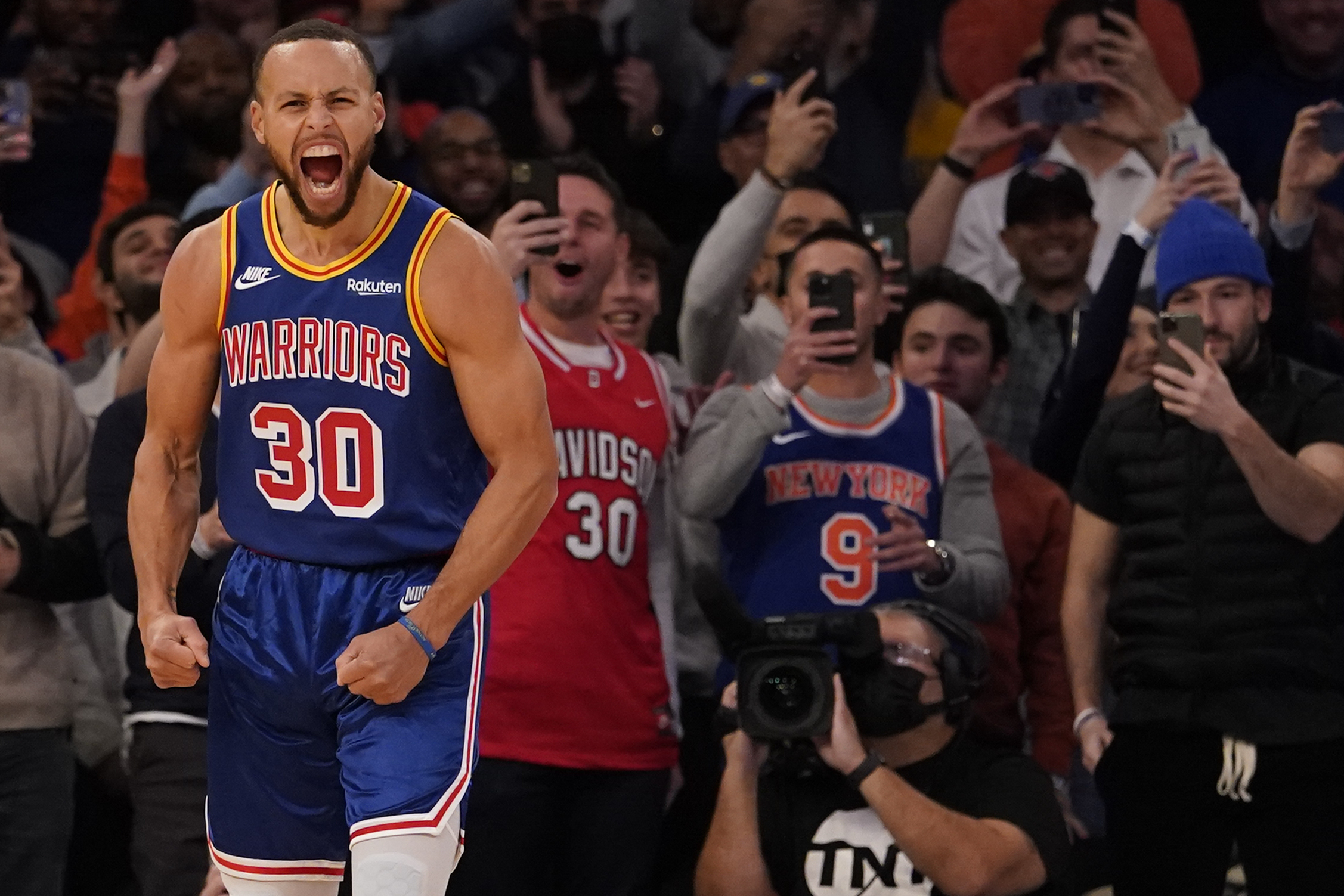 Golden State Warriors guard Stephen Curry reacts after scoring a 3-point basket during game against New York, Dec. 14, 2021.