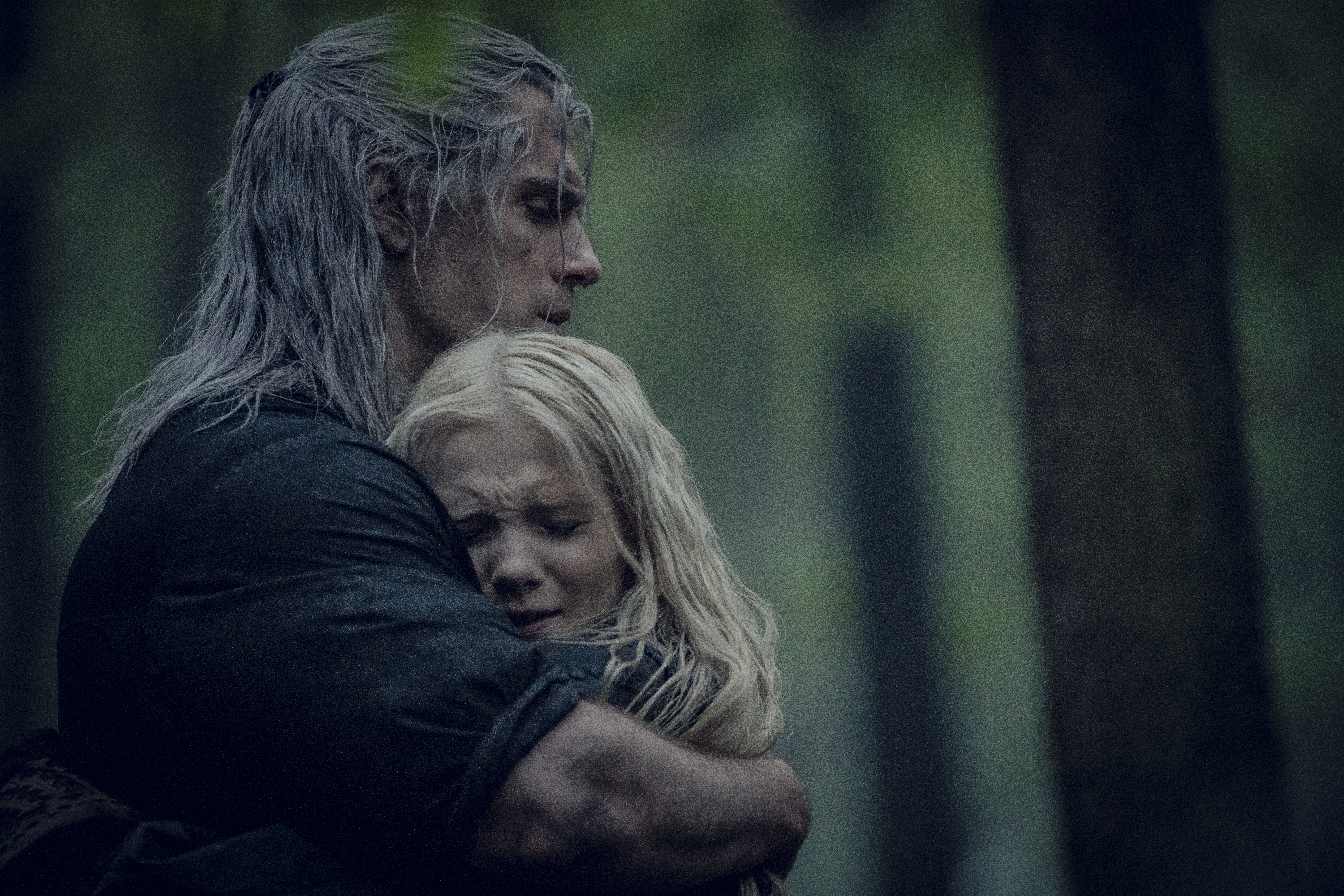 Ciri and Geralt hugging in a still from season 1 of The Witcher