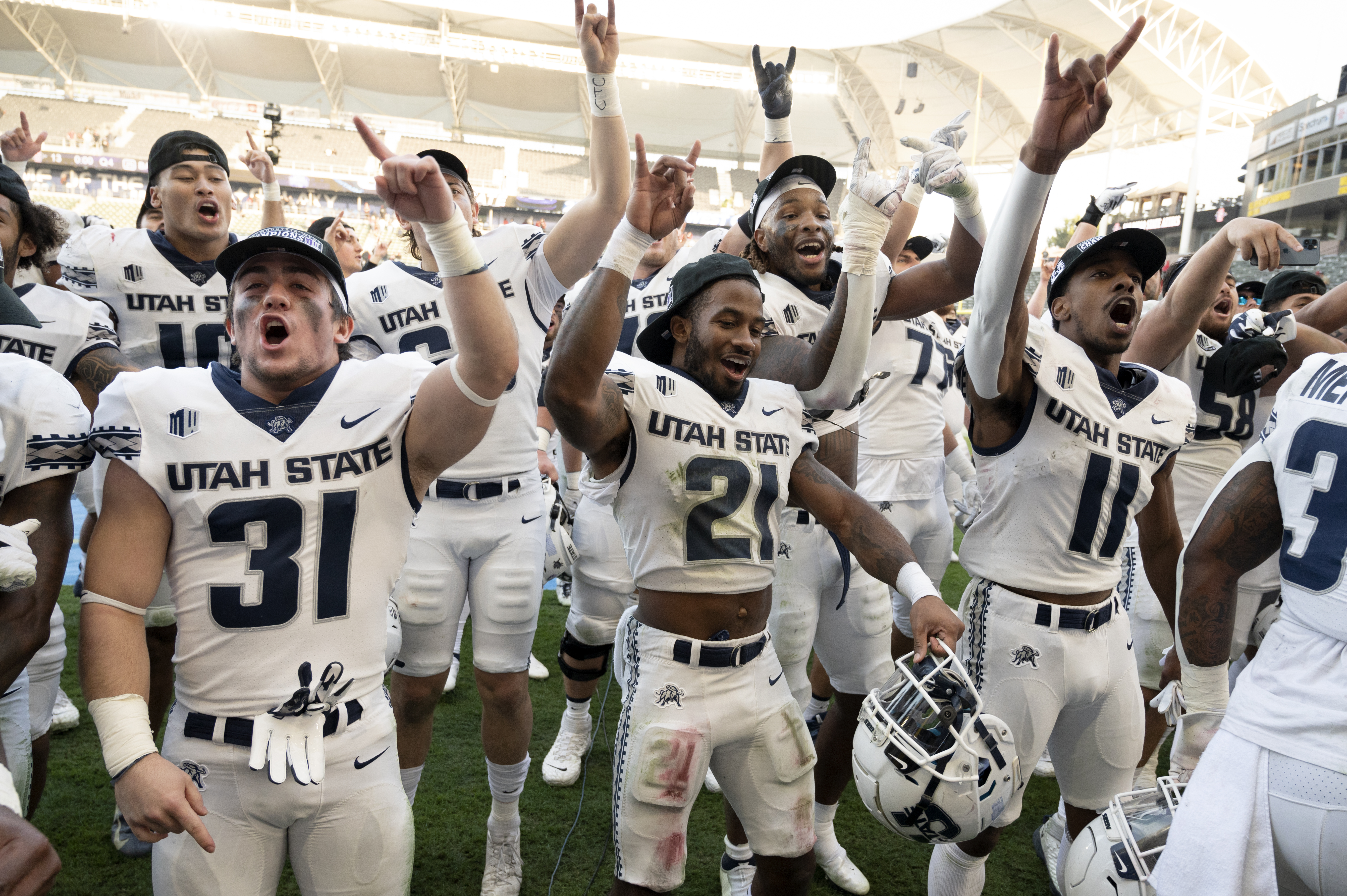 Utah State players celebrate after defeating San Diego State in the Mountain West Conference championship game.