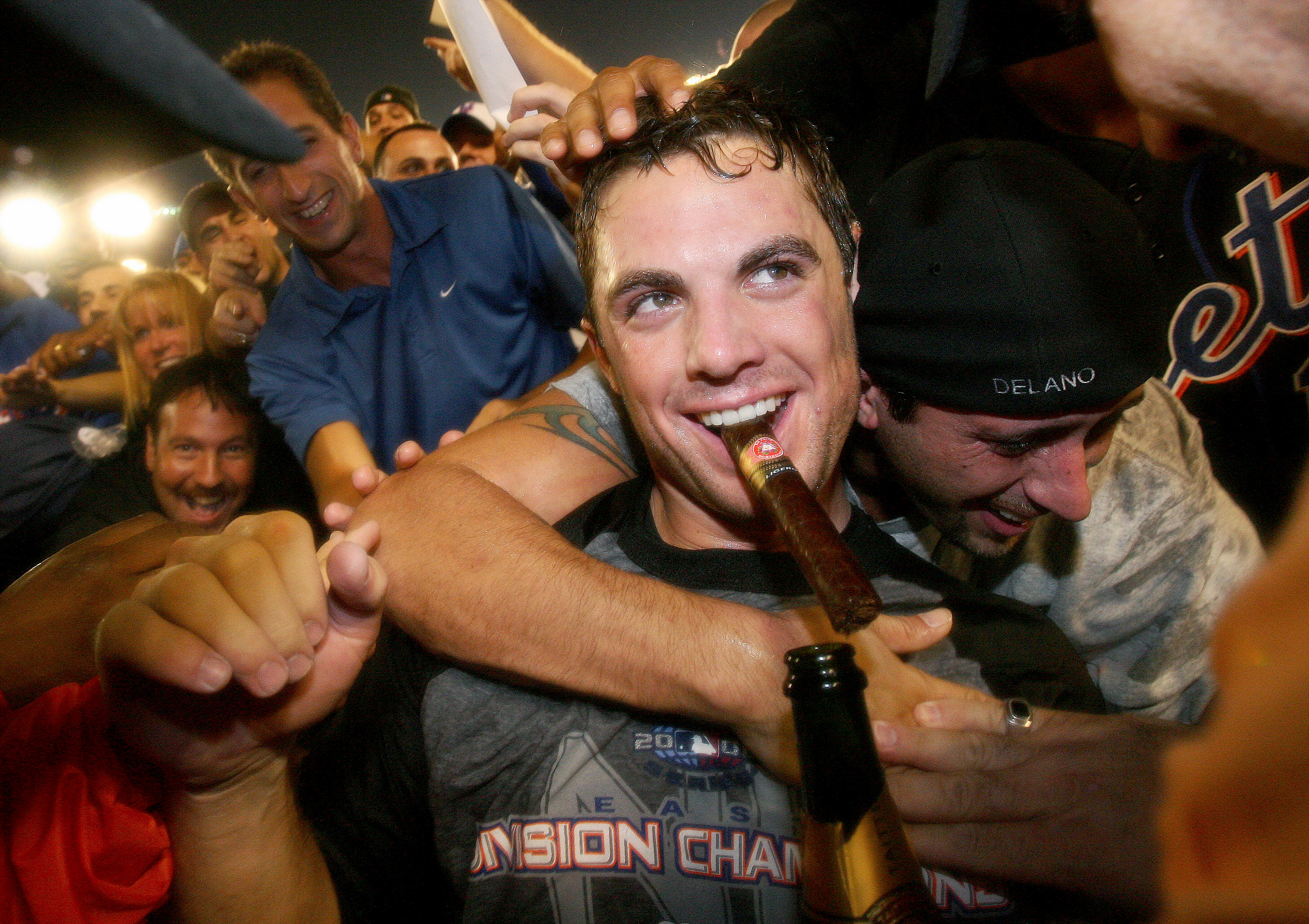 New York Mets’ David Wright celebrates with a cigar and spar