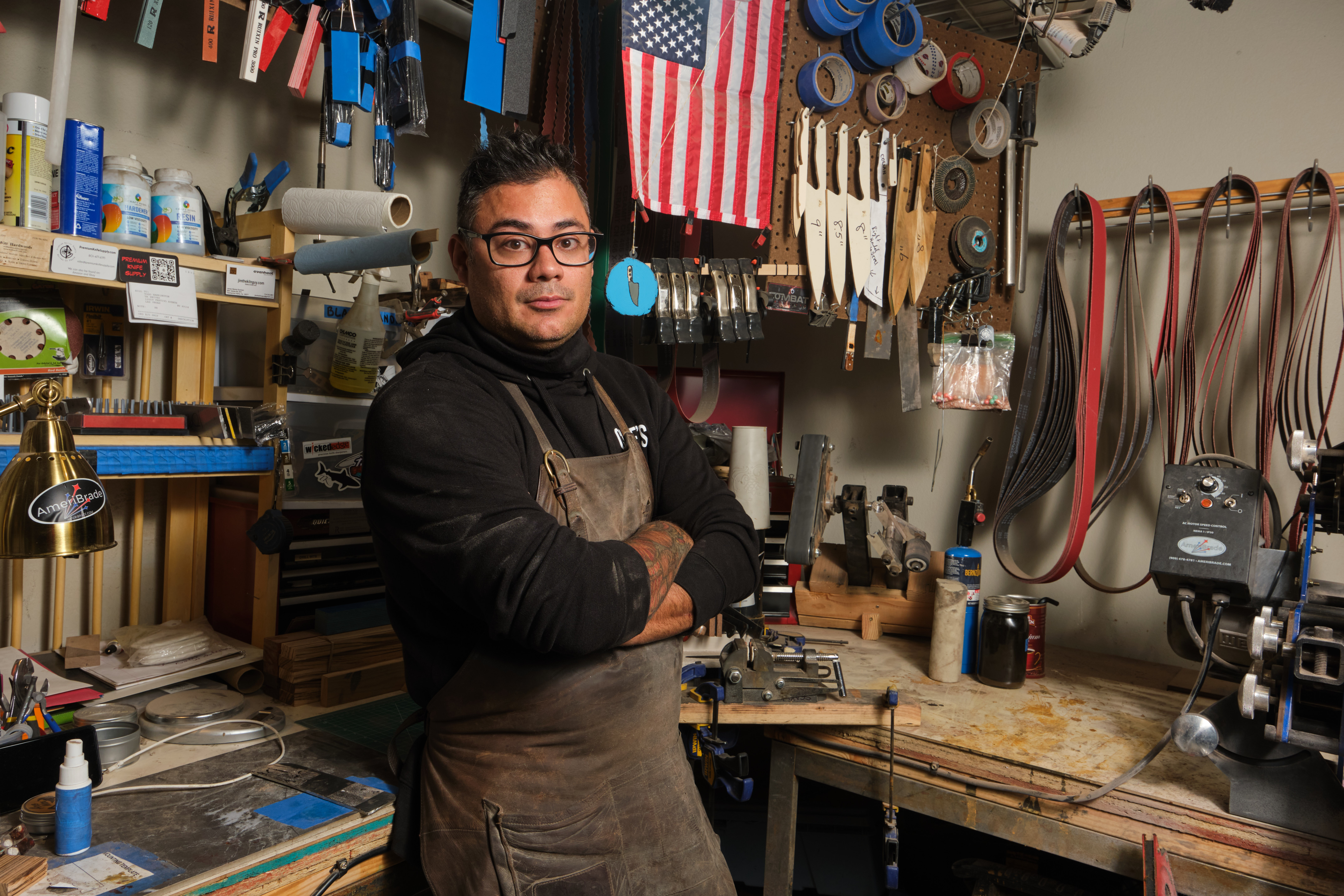 A man stands in his knife studio