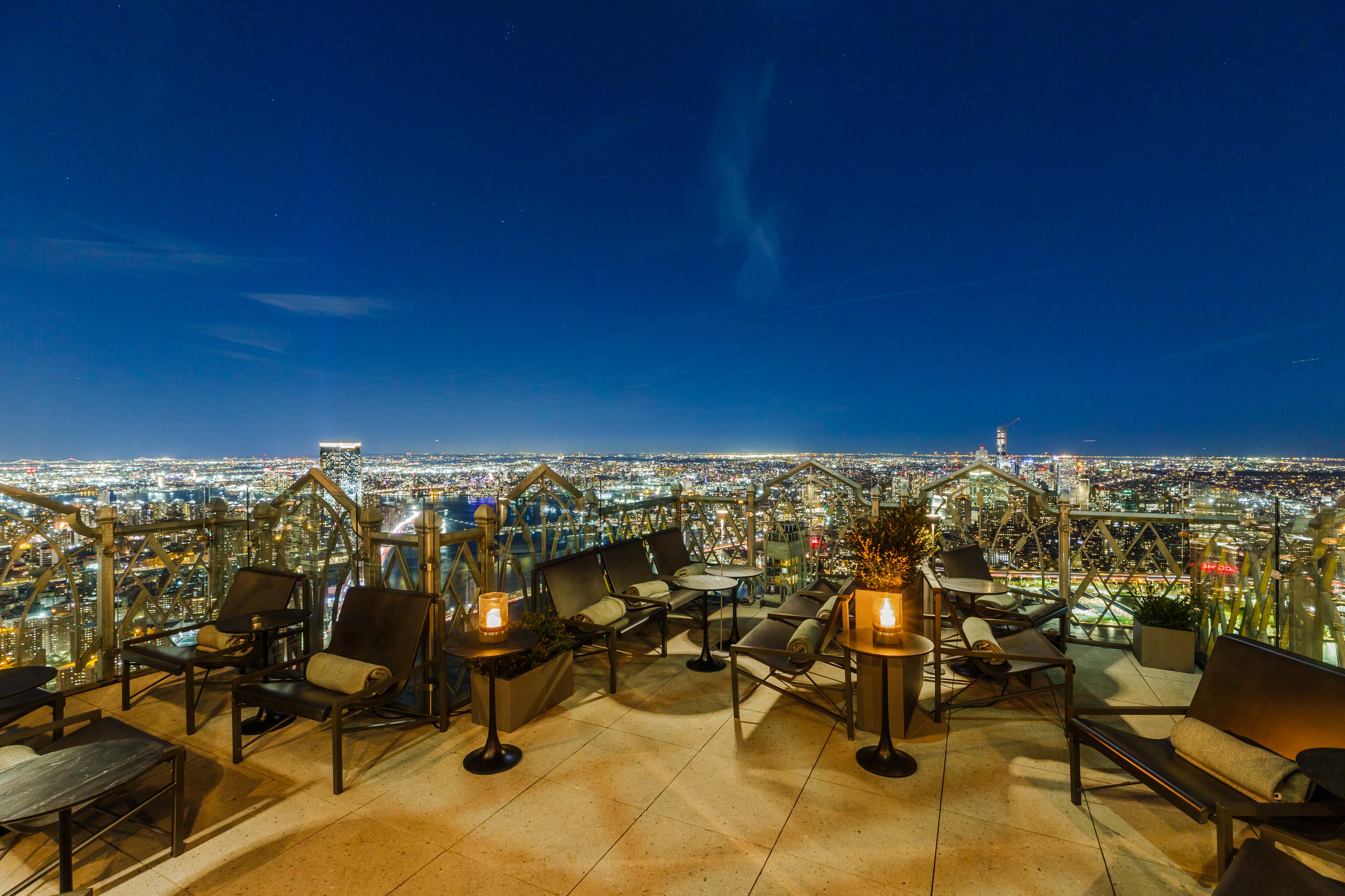 A Financial District terrace 63 floors up overlooks the Brooklyn skyline at night