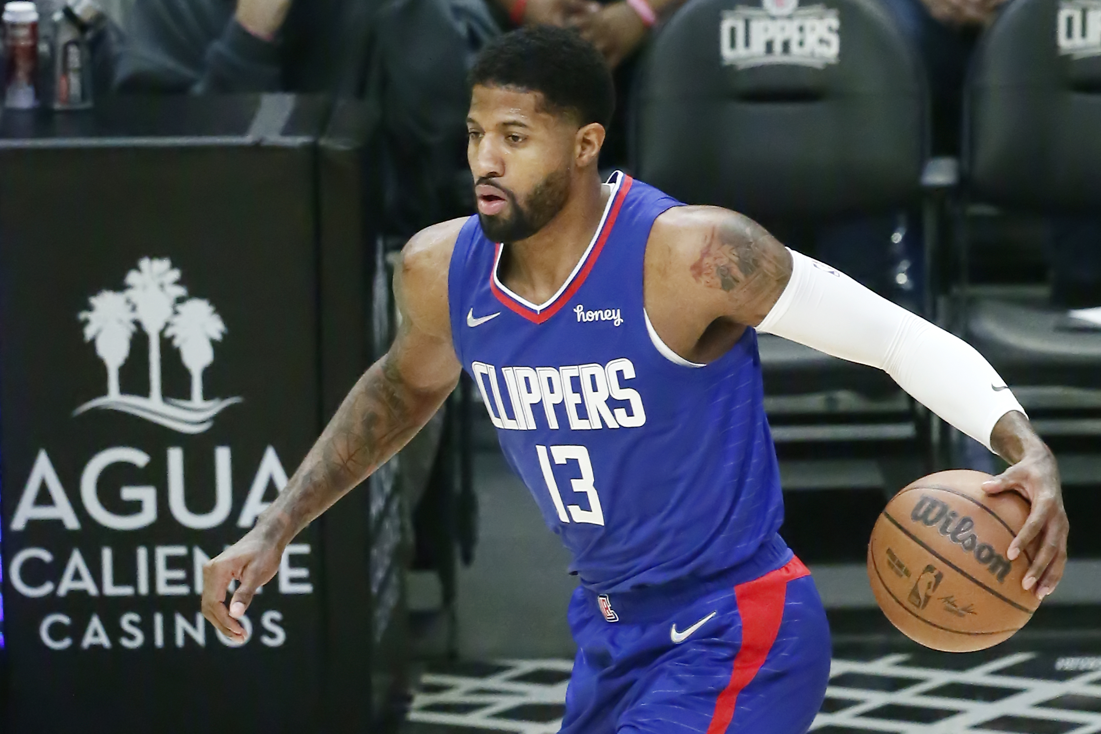 Paul George #13 of the LA Clippers dribbles the ball during a game at the STAPLES Center on December 20, 2021 in Los Angeles, California.