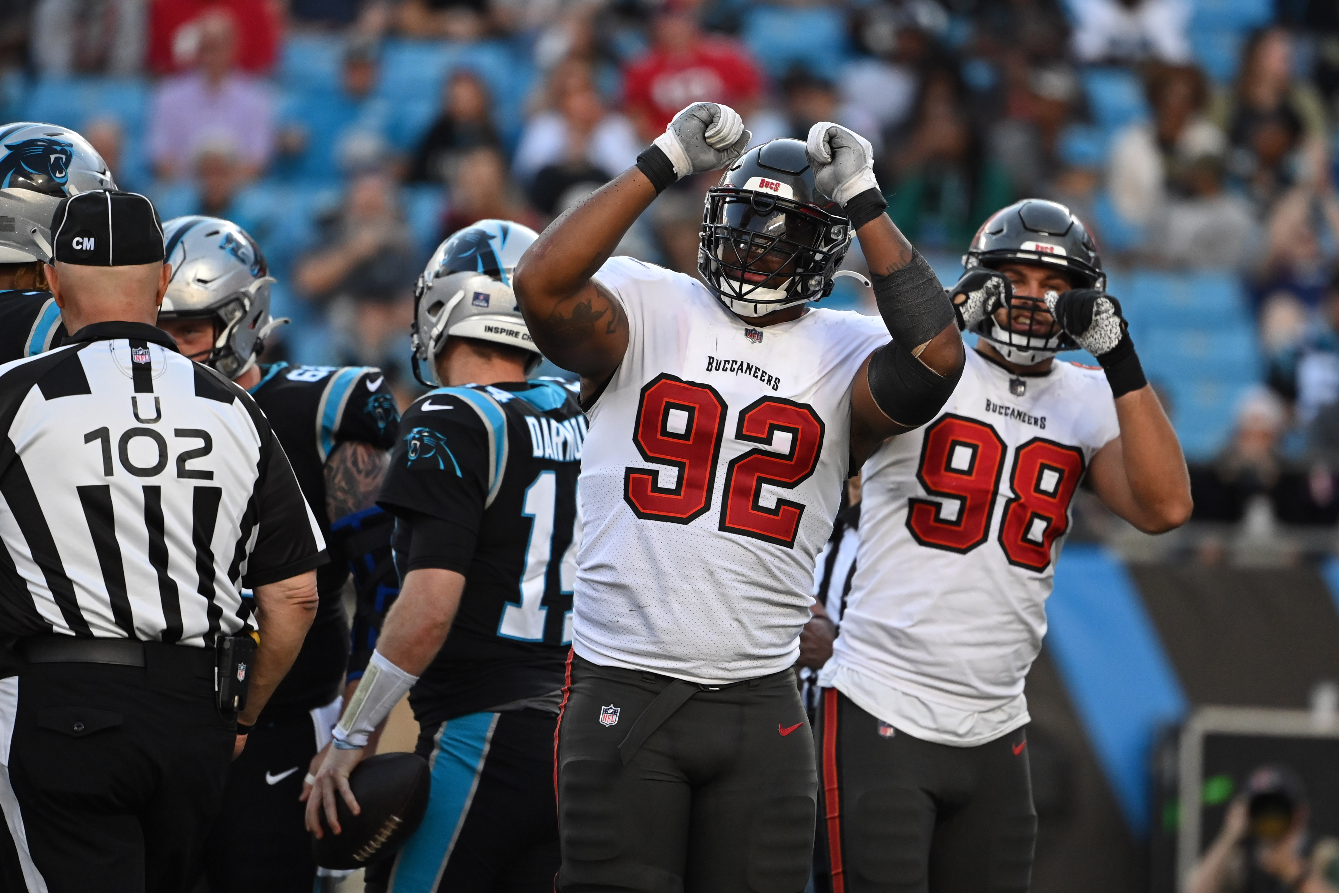 Tampa Bay Buccaneers defensive end William Gholston (92) and linebacker Anthony Nelson (98) celebrate after sacking Carolina Panthers quarterback Sam Darnold (14) in the fourth quarter at Bank of America Stadium.