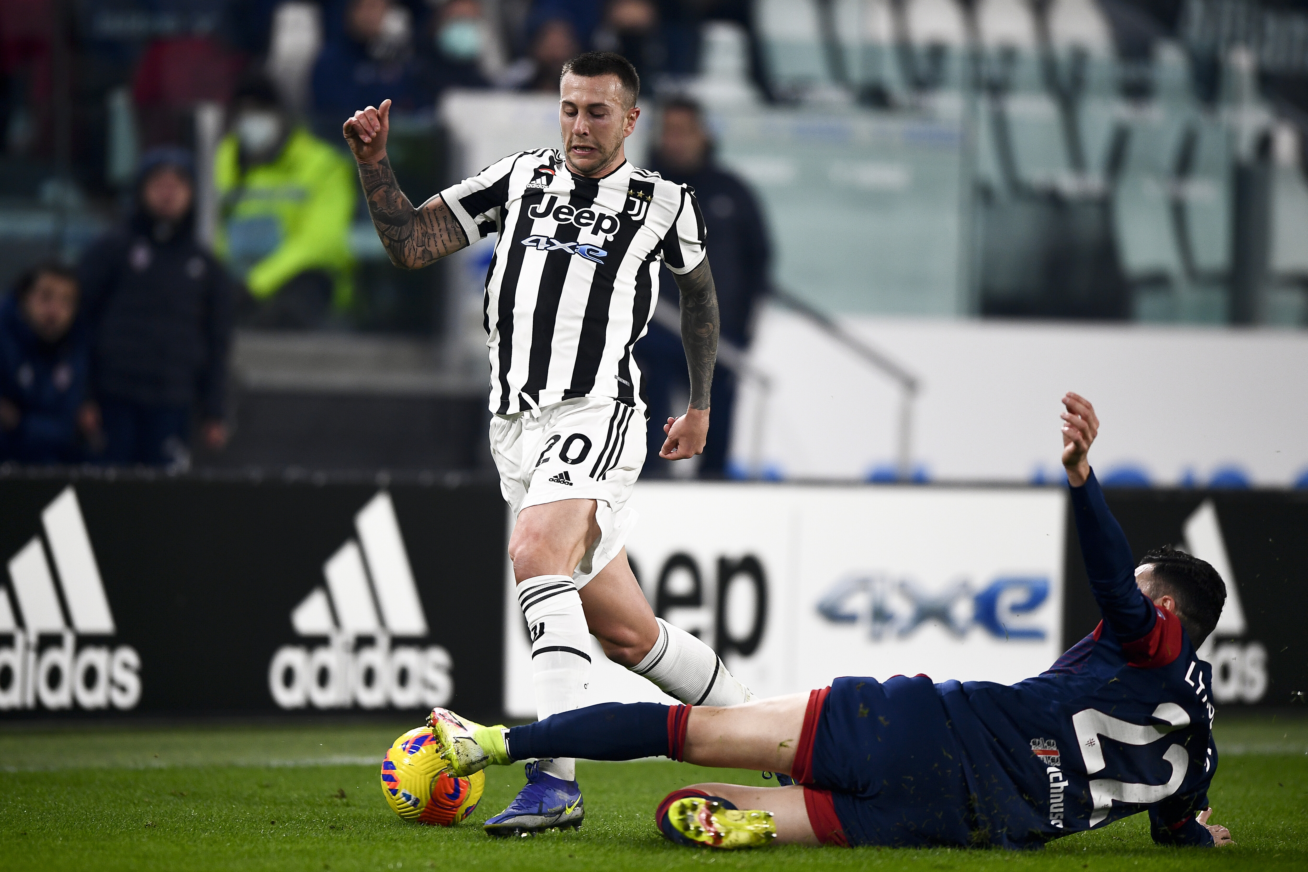 Federico Bernardeschi (L) of Juventus FC is tackled by...