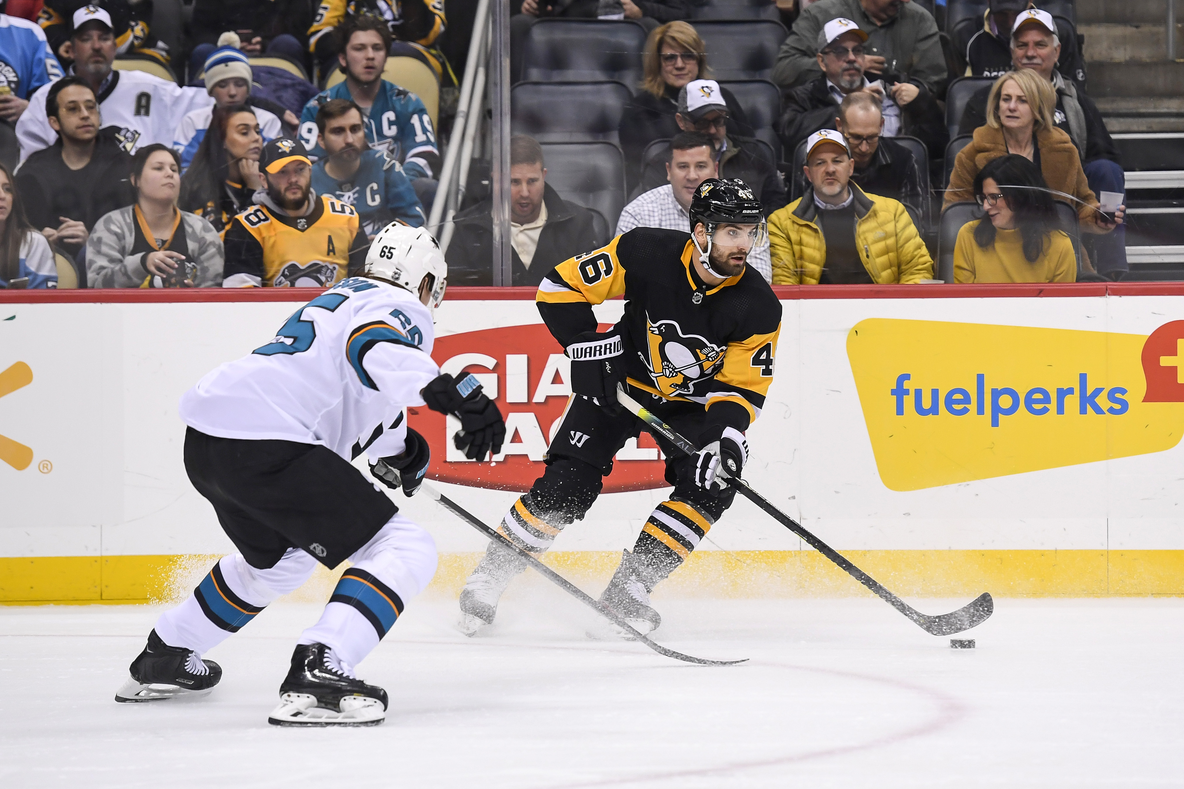 Pittsburgh Penguins Left Wing Zach Aston-Reese (46) skates with the puck while San Jose Sharks Defenseman Erik Karlsson (65) defends during the second period in the NHL game between the Pittsburgh Penguins and the San Jose Sharks on January 2, 2020, at PPG Paints Arena in Pittsburgh, PA.