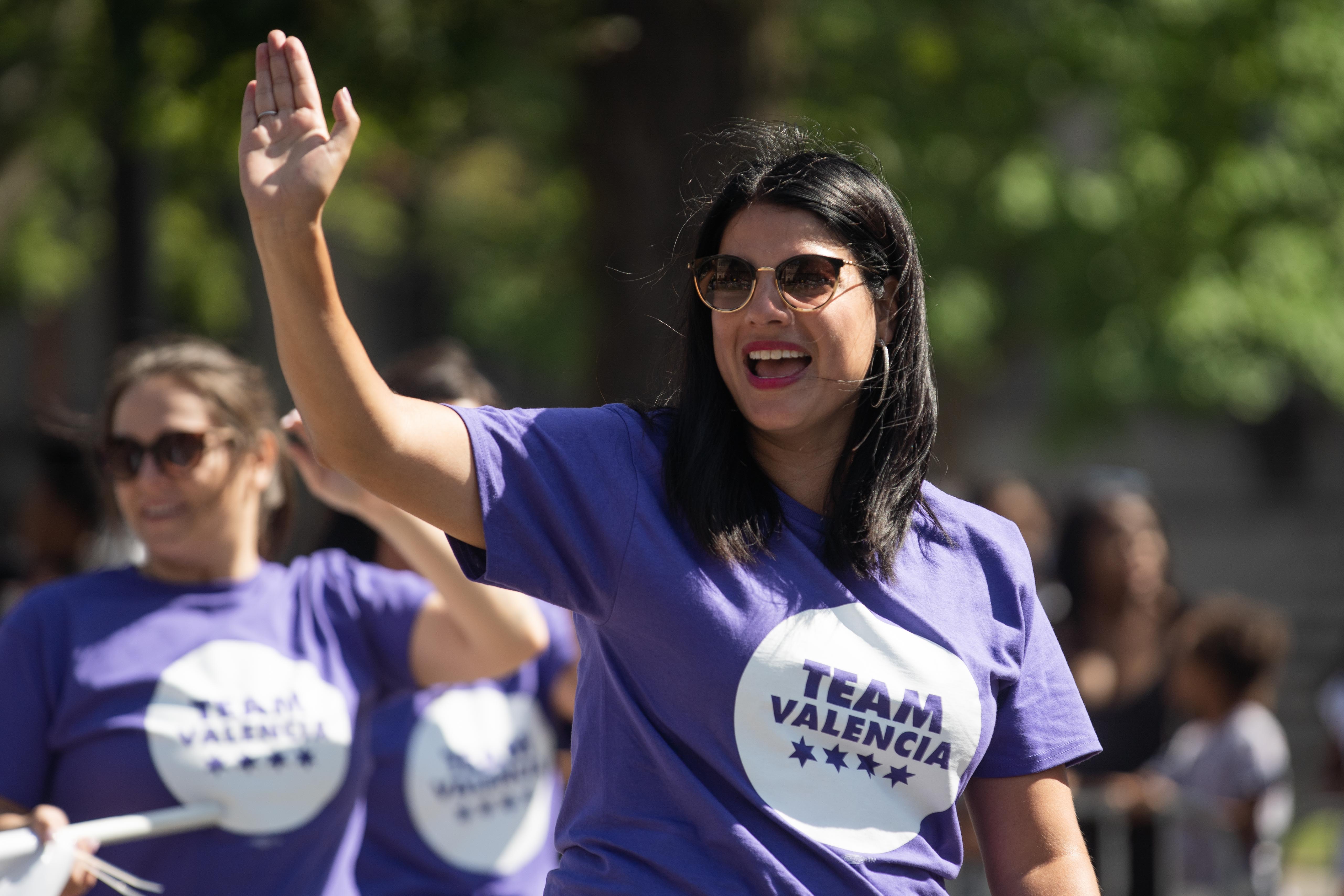 City Clerk Anna Valencia, running for secretary of state, waves to parade-goers during the Bud Billiken Parade in the Bronzeville neighborhood, Saturday, Aug. 14, 2021.