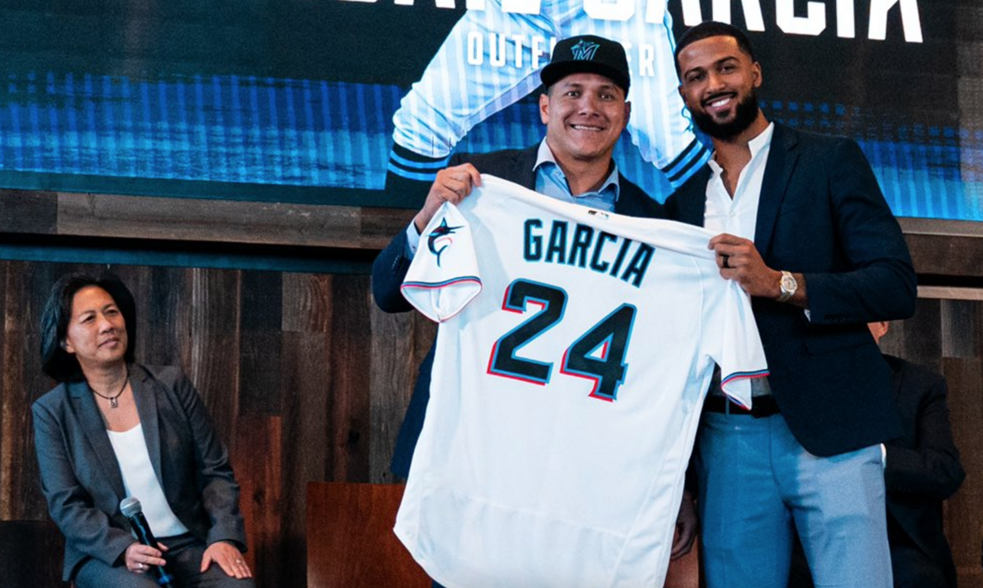 Sandy Alcantara presents new teammate Avisail Garcia with his No. 24 Miami Marlins jersey during a press conference at LoanDepot Park