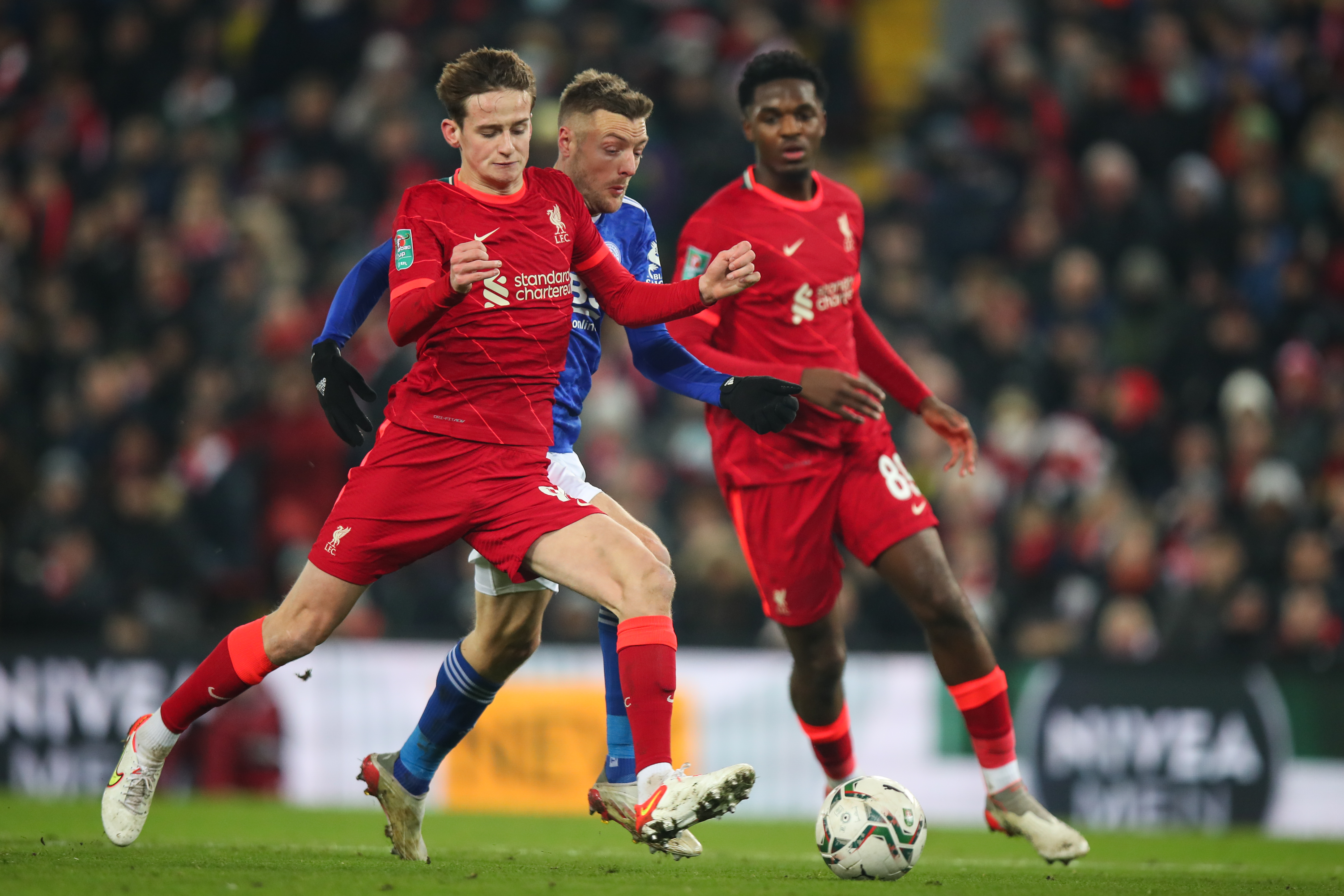 Tyler Morton of Liverpool and Jamie Vardy of Leicester City during the Carabao Cup Quarter Final match between Liverpool and Leicester City at Anfield on December 22, 2021 in Liverpool, England.