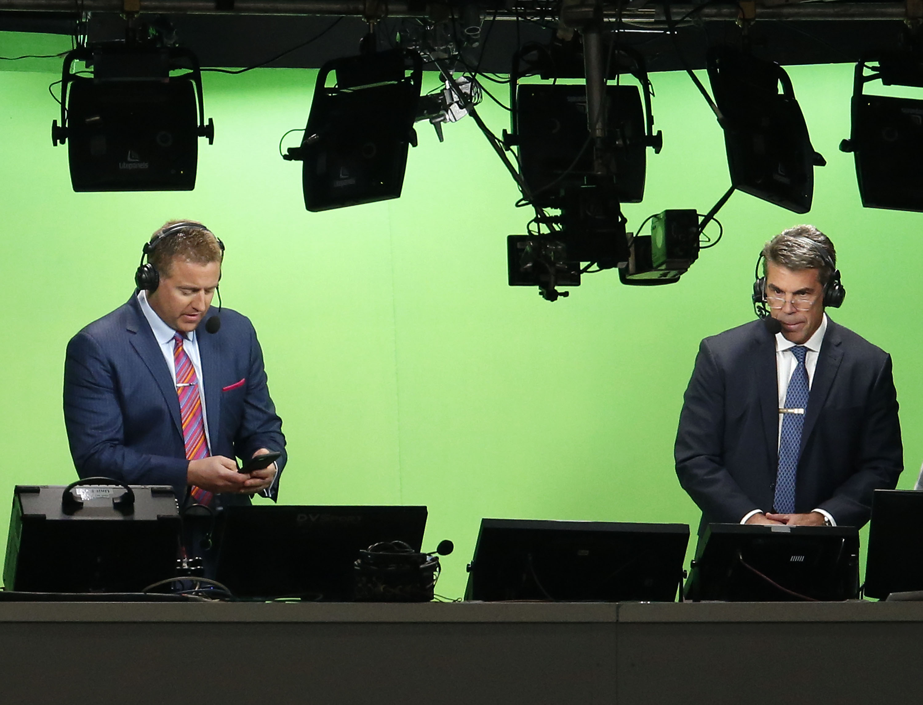 ESPN television personalities Kirk Herbstreit and Chris Fowler prepare for the College Football Playoff National Championship game between the Georgia Bulldogs and the Alabama Crimson Tide at Mercedes-Benz Stadium on January 8, 2018 in Atlanta, Georgia.