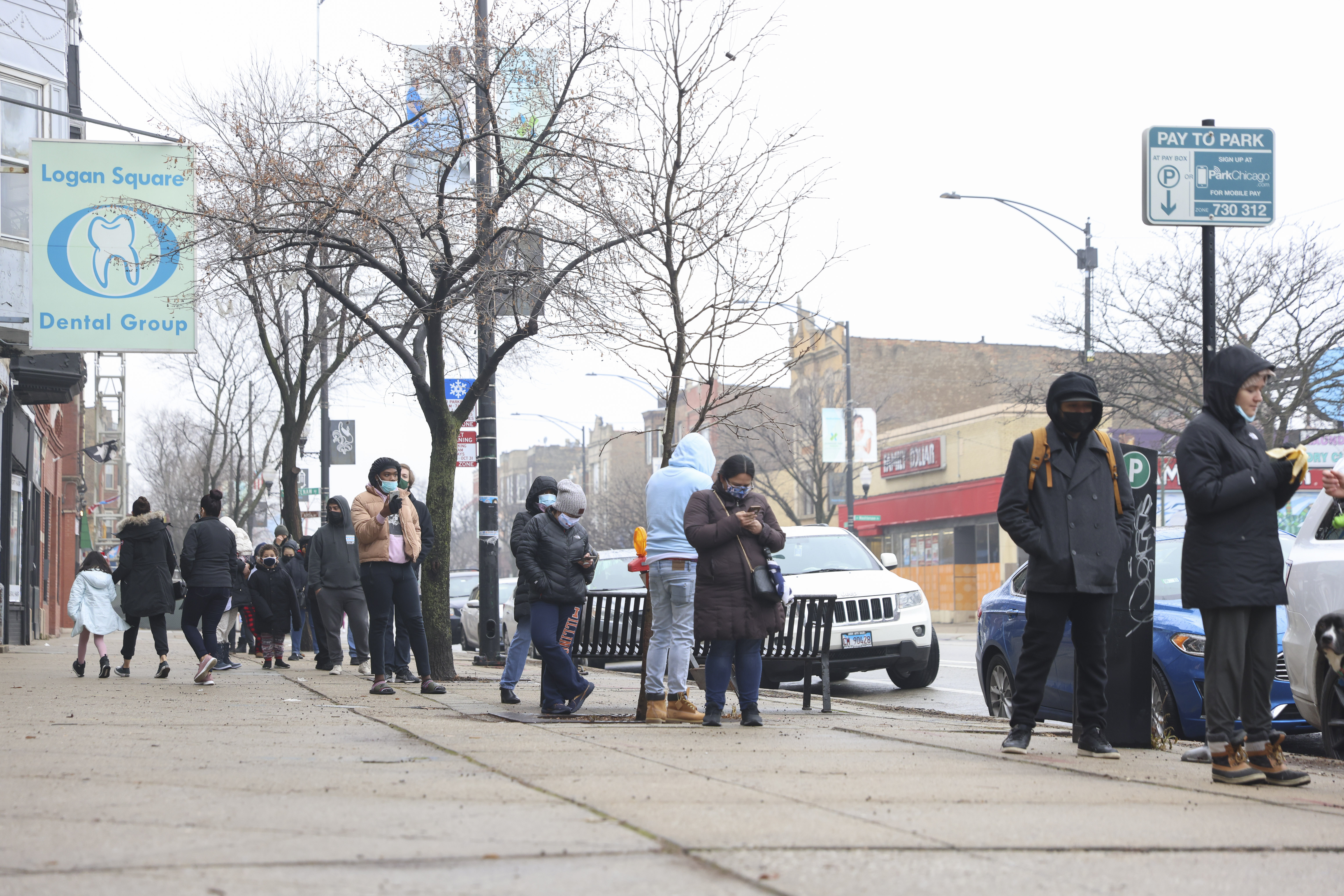 People wait in line to get tested for COVID-19 at a test site in Humboldt Park two weeks ago.