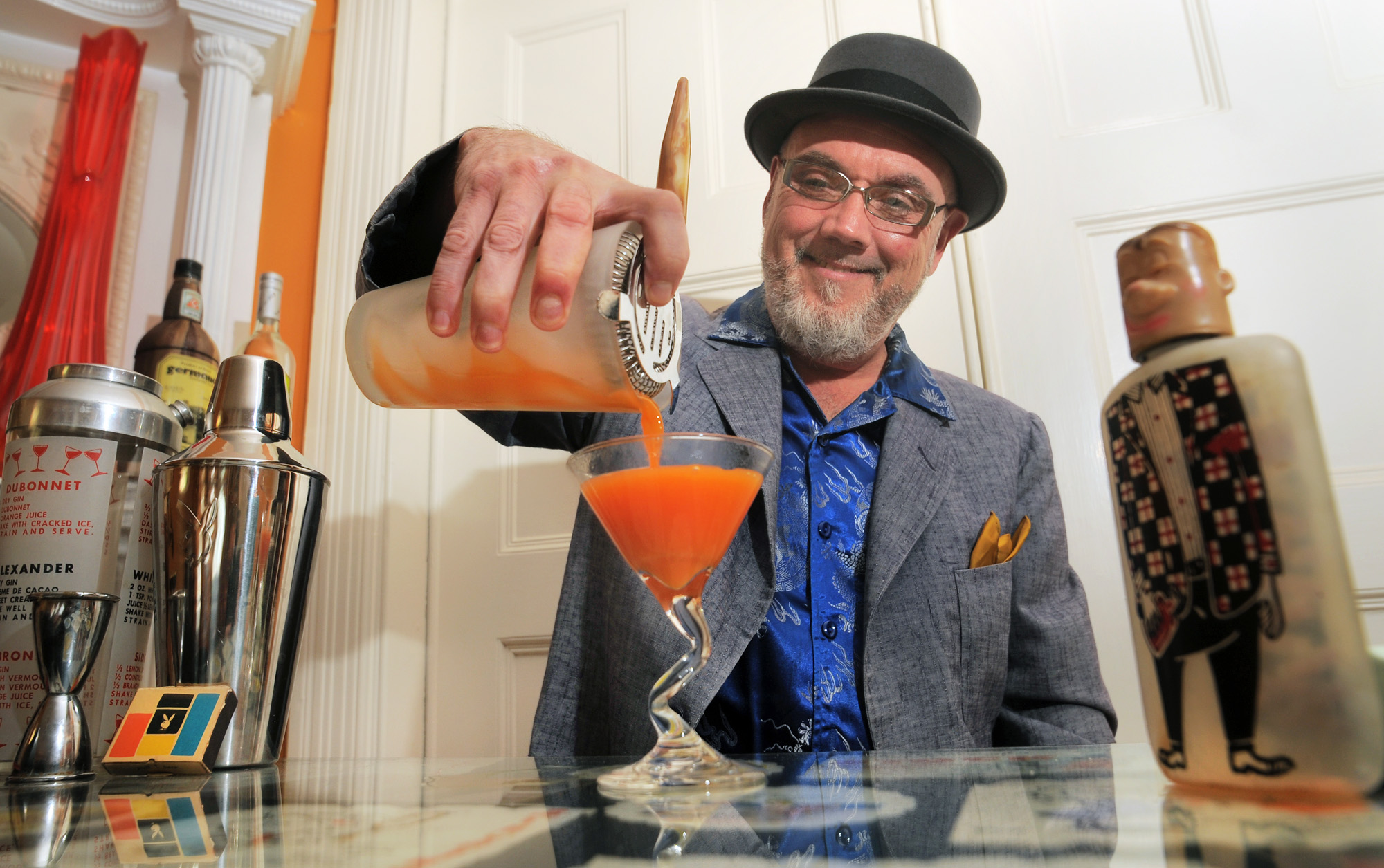 Brother Cleve, who taught many of today’s top bartenders pours one of his notable cocktail’s called a Bossa Nova at his home near Uphams Corner.