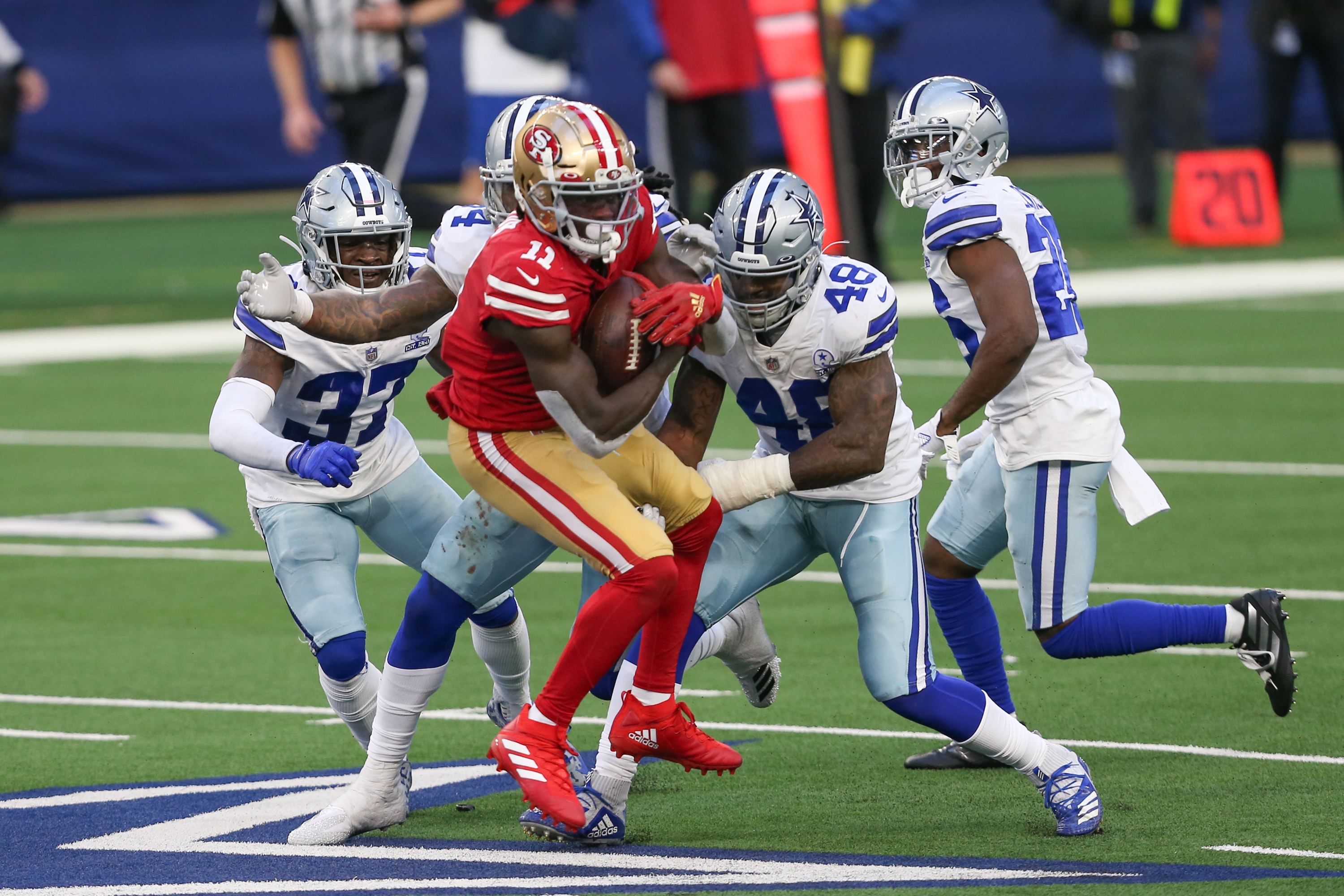 49ers Brandon Aiyuk is tackled by Cowboys defenders on 12/20/2020