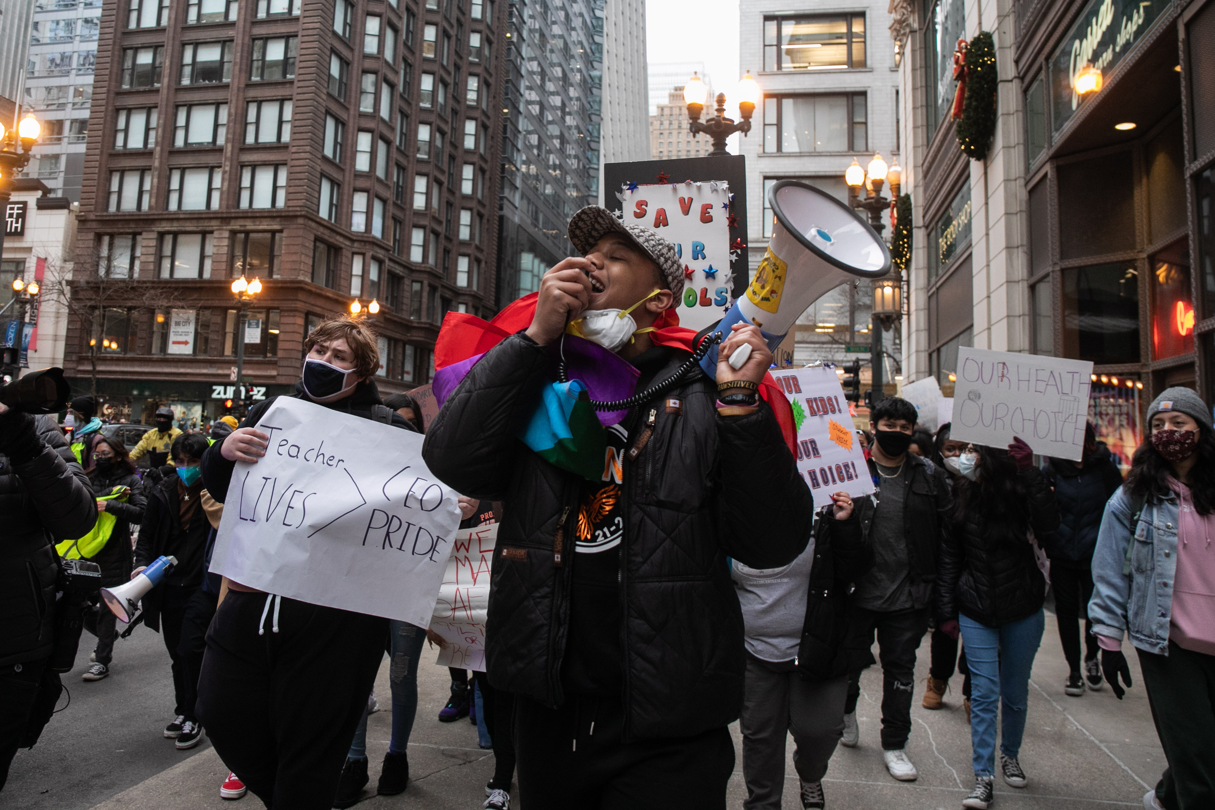 Hundreds of Chicago Public Schools students protest along West Madison Street after gathering outside the Chicago Public Schools headquarters in the Loop during a district-wide walkout to demand Mayor Lori Lightfoot, Chicago Department of Public Health Dr. Allison Arwady and Chicago Public Schools CEO Pedro Martinez to include them in the conversation about COVID-19 safety in schools, Friday afternoon, Jan. 14, 2022. Many students advocated for remote learning and stood with the Chicago Teachers Union which has been pushing for improved COVID-19 safety protocols in schools. | Pat Nabong/Sun-Times