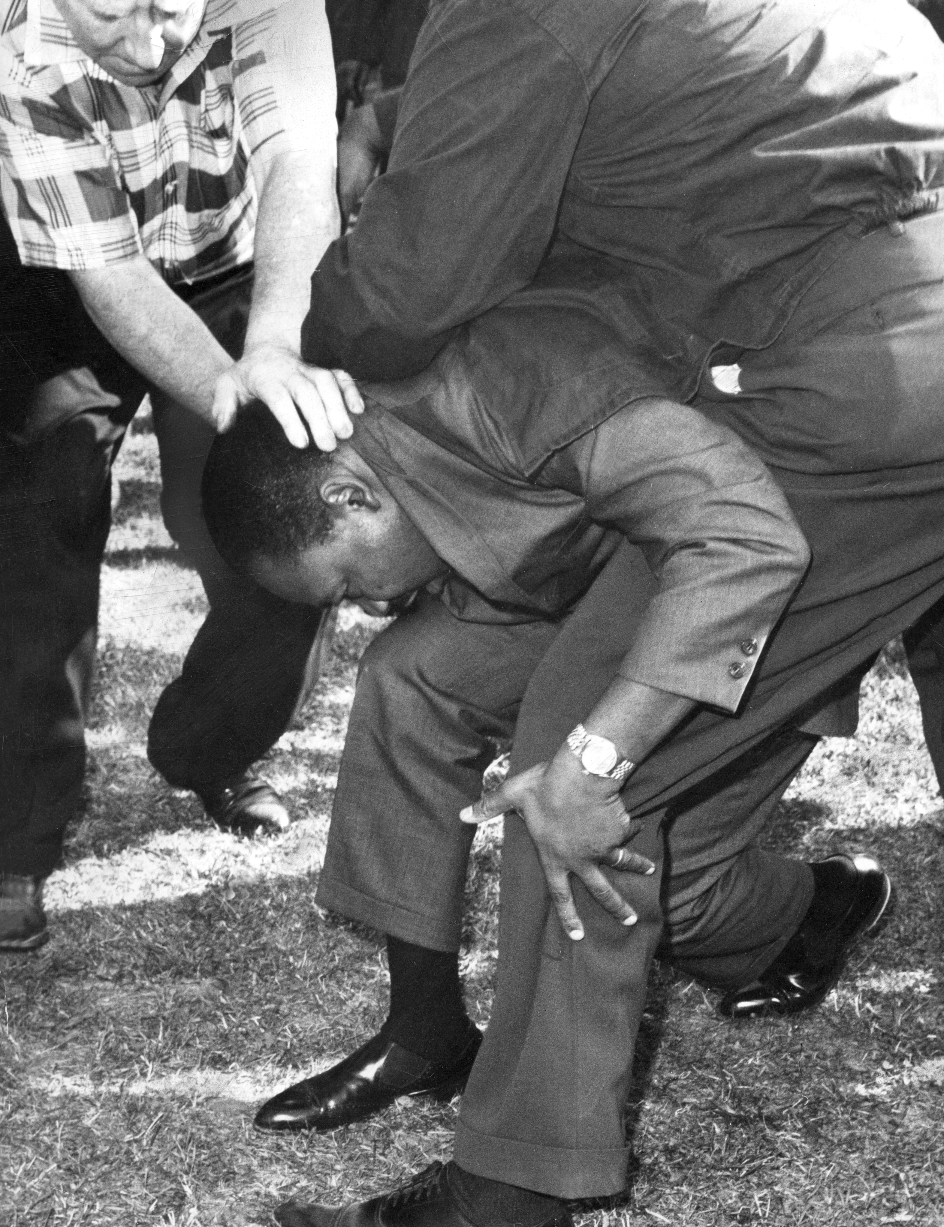 The Reverend Martin Luther King Jr. falls after being struck by a rock from a taunting mob in Marquette Park Aug. 5, 1966. | Sun-Times file photo