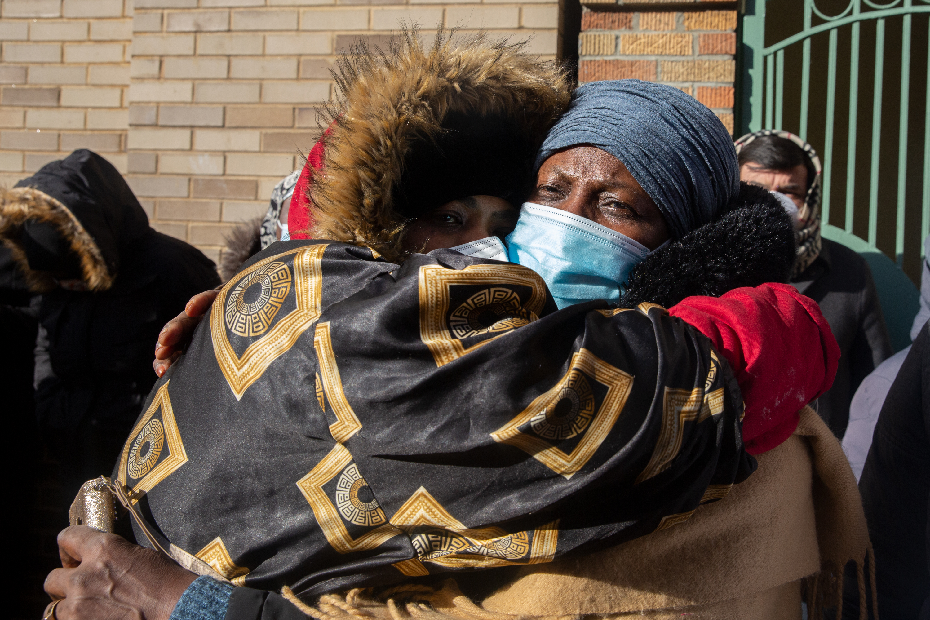 Fatou Ndiaye, right, embraces, Isatou Jallow during a funeral at the Islamic Culture Center on East 166th Street for 15 people killed in a Bronx building fire, Jan. 16, 2022.